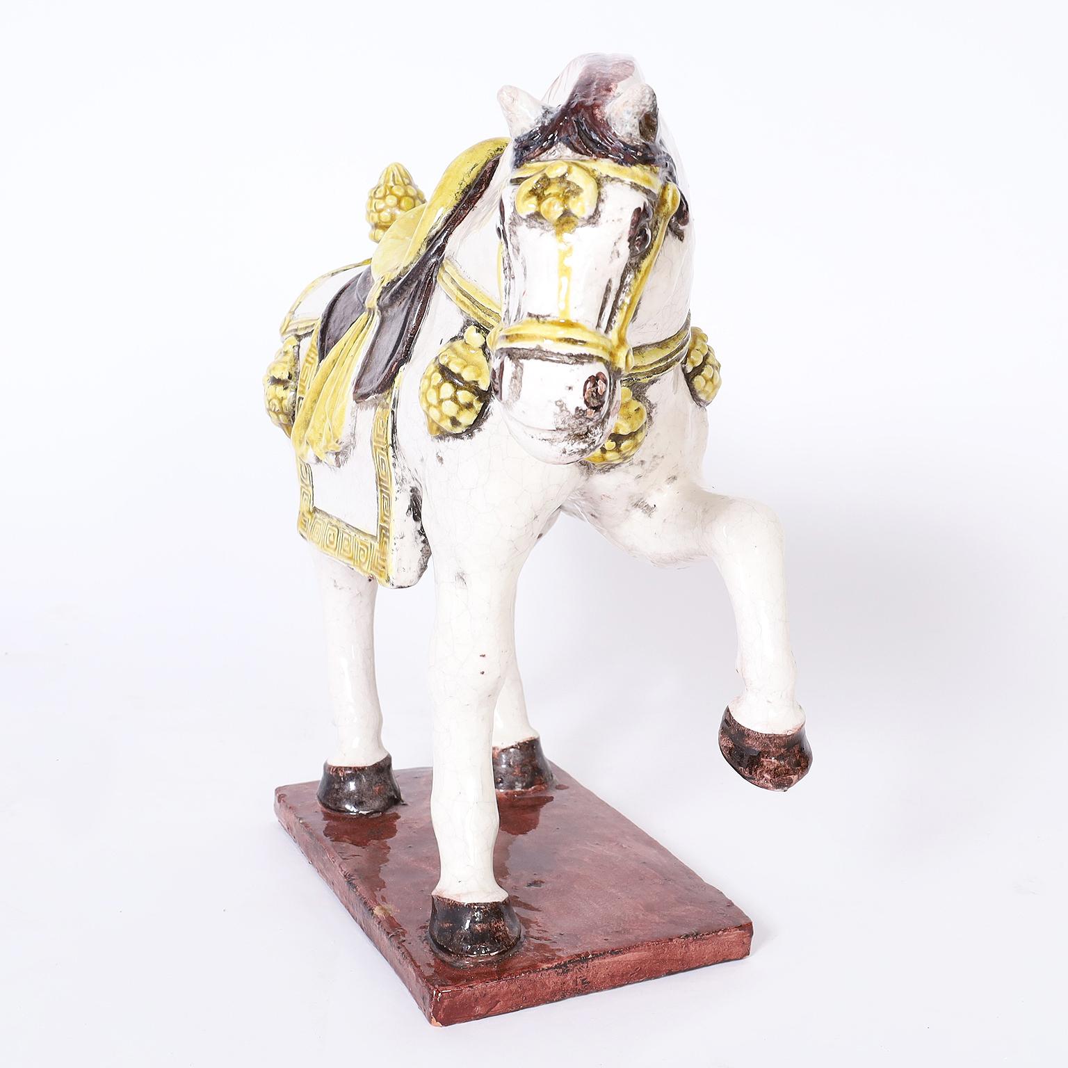 Terra cotta horse sculpture or object of art decorated in holiday attire under glaze. Signed made in Italy on the bottom.