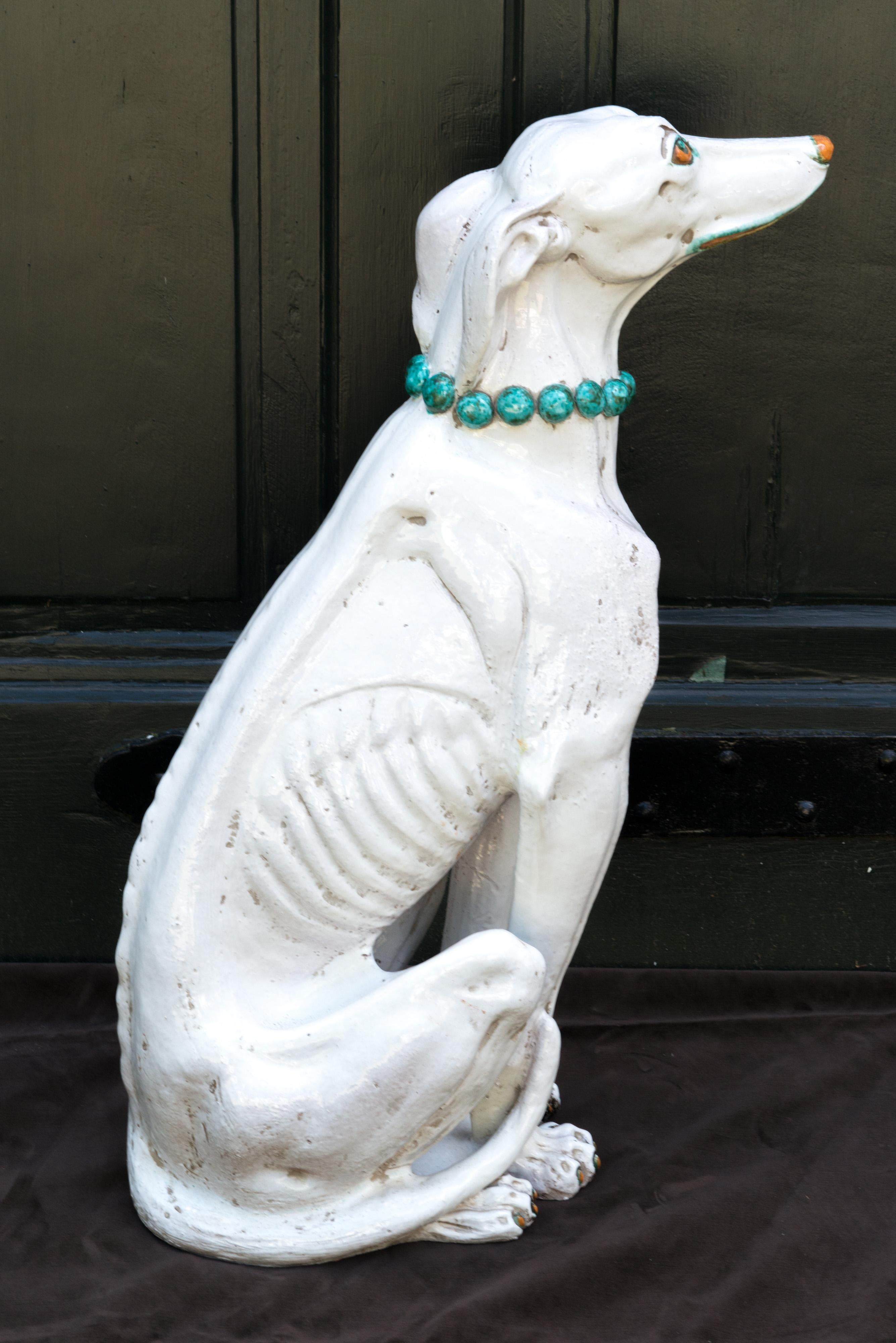 Glazed terra cotta bejeweled greyhound, probably Italian, unmarked. He is adorned with a turquoise beaded necklace, turquoise eyeliner and lipliner.
Handsome dog!