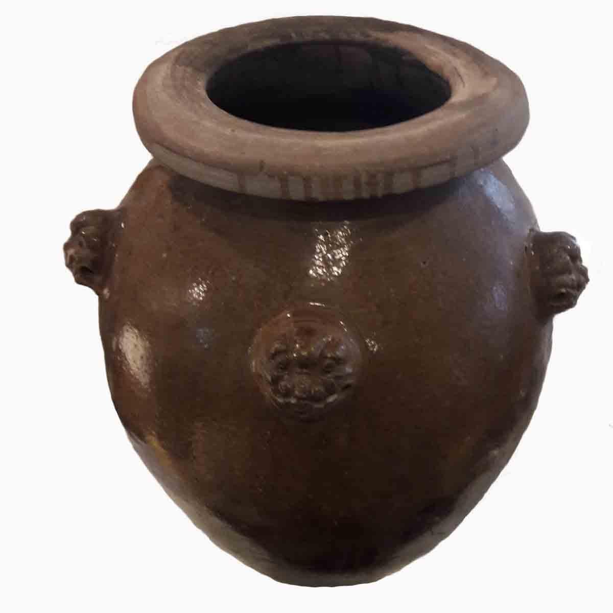 A tall terracotta vase or jar with light brown glaze finish, from India, mid-20th century. Three dragon-shaped handles, and dragon decorative carving. Can be used indoors as a singular vase, or outdoors as a planter.