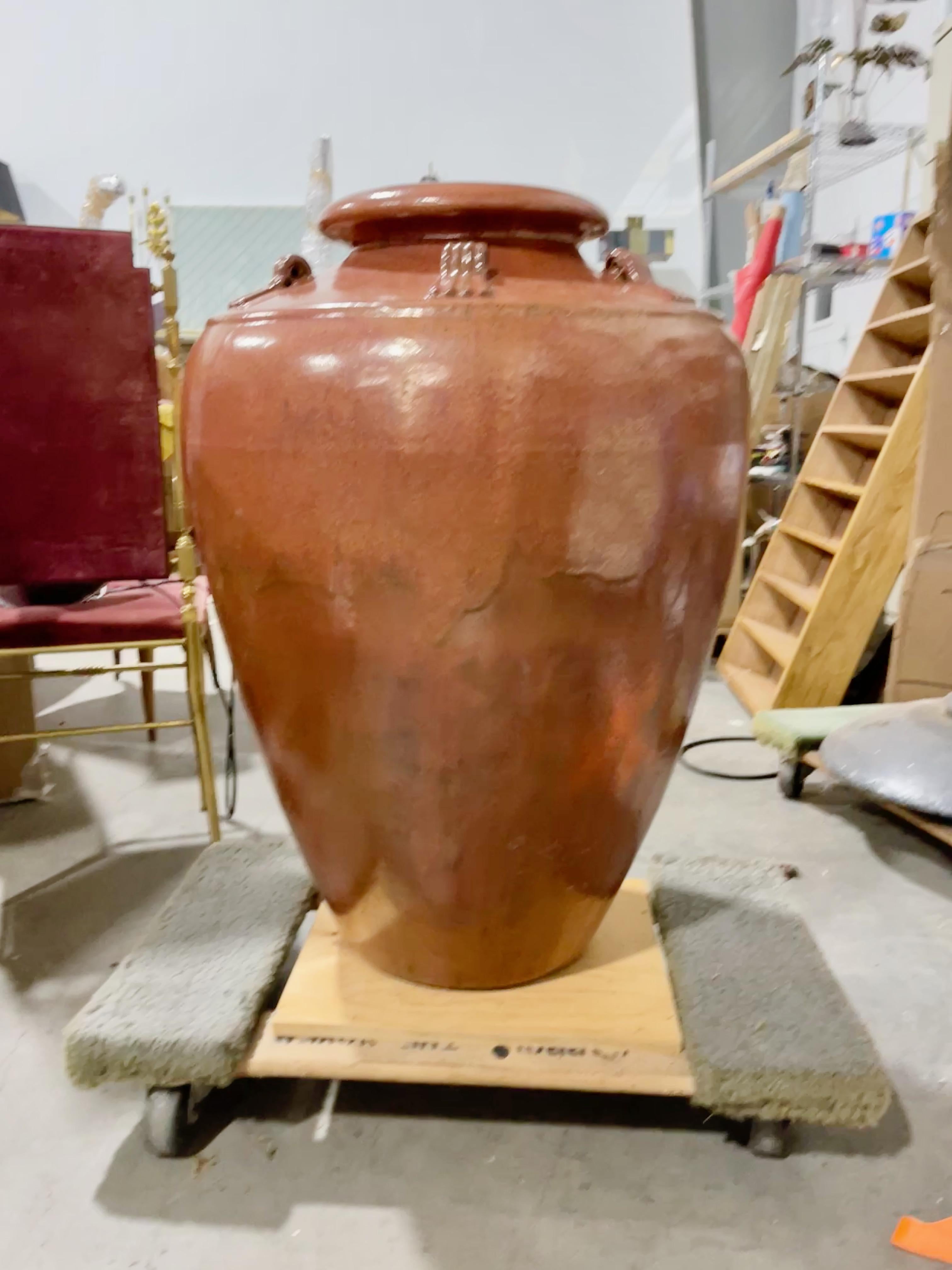 Italian glazed terracotta olive oil vase.
33” high. 
25” diameter 
6” opening