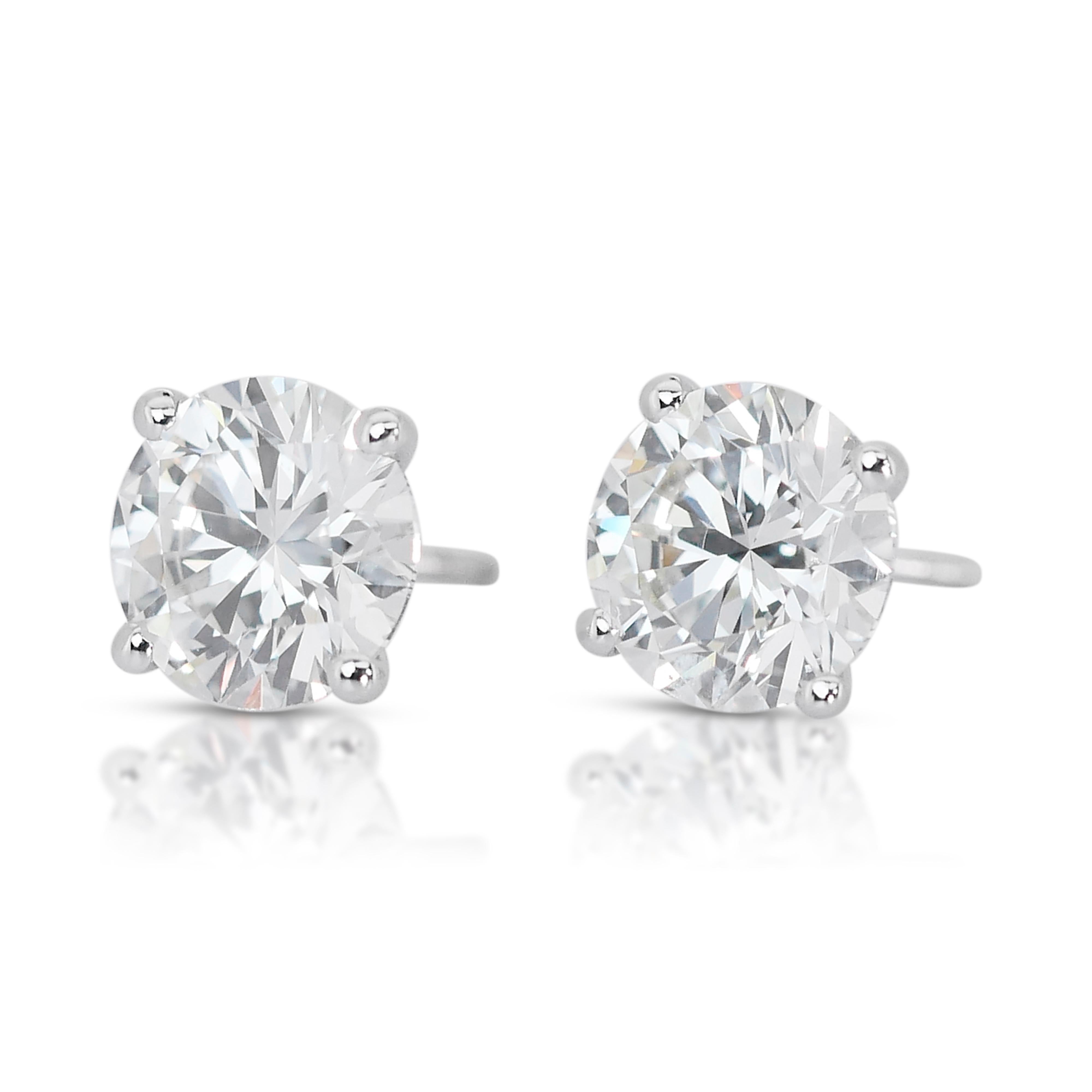 Gleaming 18k White Gold Natural Diamond Stud Earrings w/3.10 ct - GIA Certified

These captivating diamond stud earrings embody timeless elegance with a touch of modern luxury. Crafted in gleaming 18k white gold, the earrings showcase two stunning