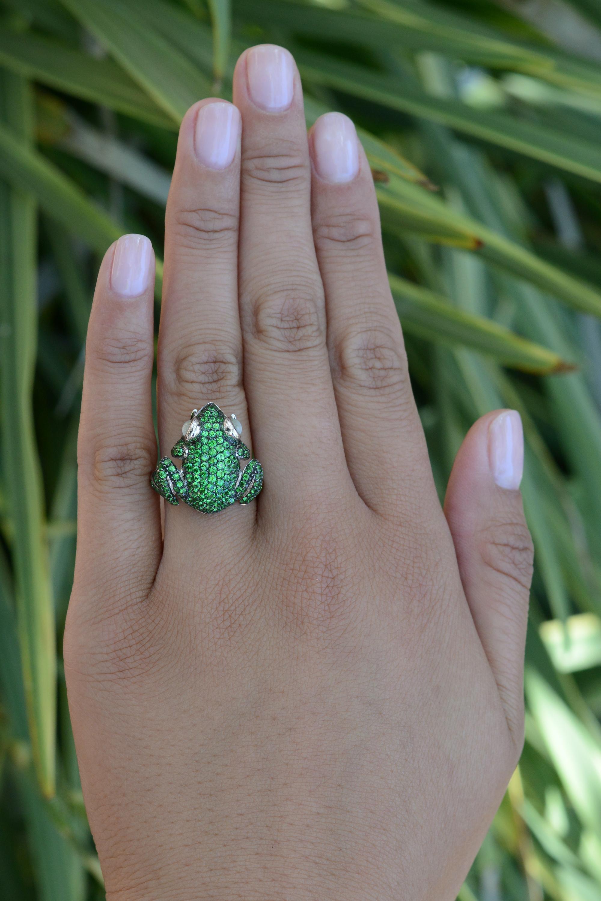 Your search for eccentric vintage estate rings finishes upon a luxurious lily pad. A captivating combination of tsavorite and cat's eye chrysoberyl gems fashioned into a bespoke frog makes a curious and entertaining splash. The luxurious 18 karat