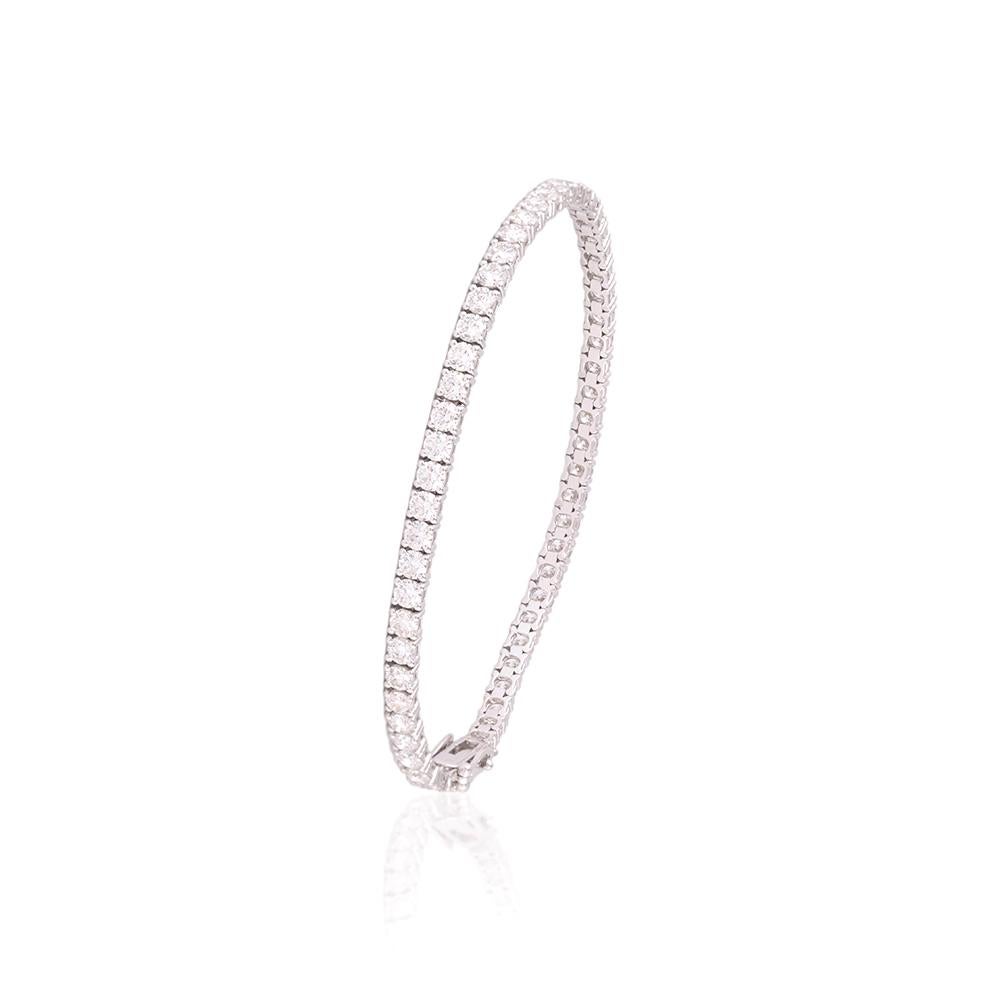 Crafted in 9.64 grams of 18-karat White Gold, The Balderdash Tennis Bracelet contains 57 Stones of Round Diamonds with a total of 6.31-Carats in F-G Color and VVS Clarity.

CONTEMPORARY AND TIMELESS ESSENCE: Crafted in 14-karat/18-karat with 100%