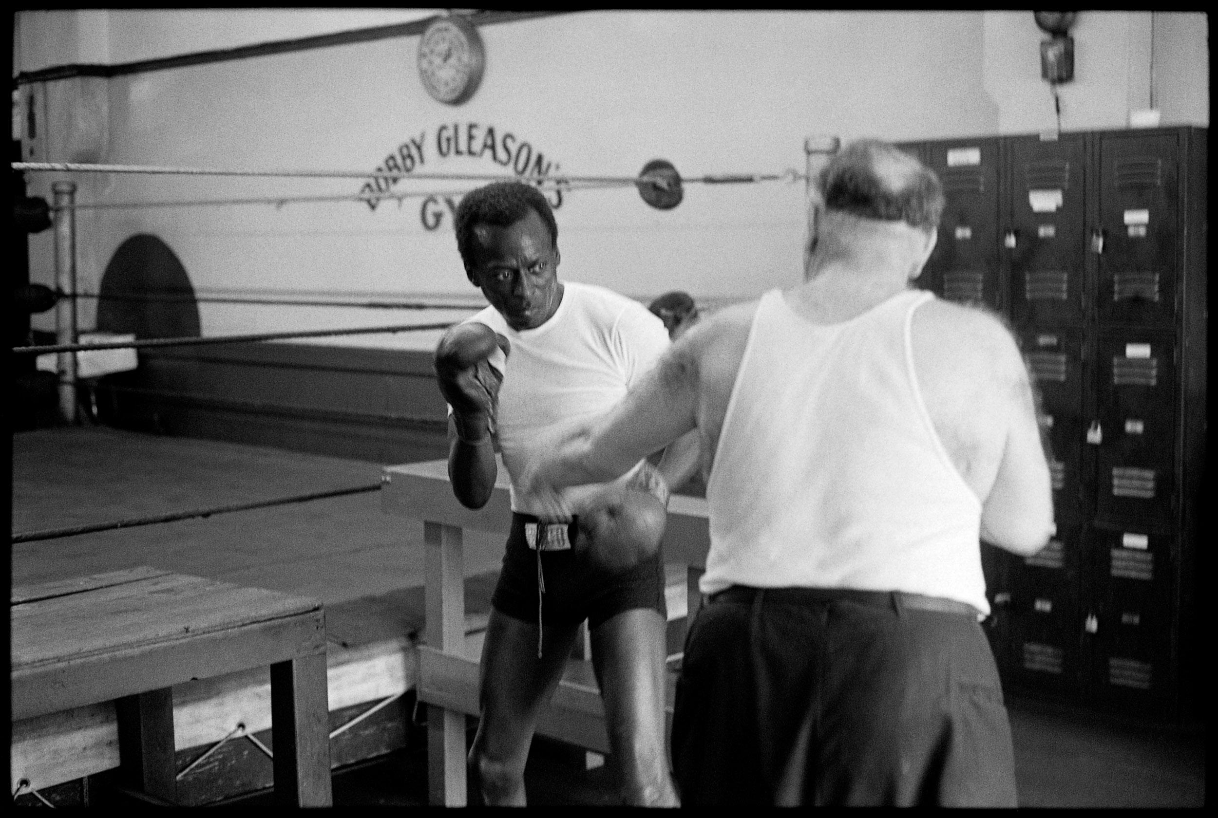 Miles Davis warming up with a trainer at Gleason's Gym, NYC, 1970