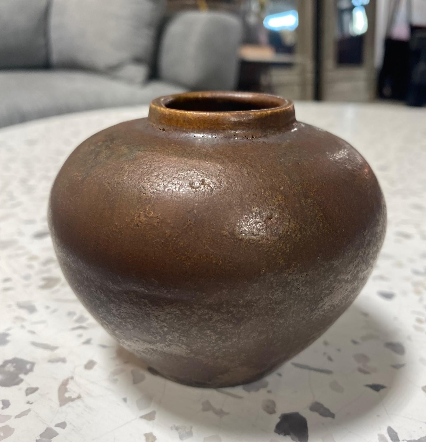 A very rare early work featuring a dark chocolate brown glaze by master Mid-Century Modern ceramist/potter Glen Lukens whose work has become quite collectible and relatively scarce and difficult to find.

The work is signed and dated (1924) by