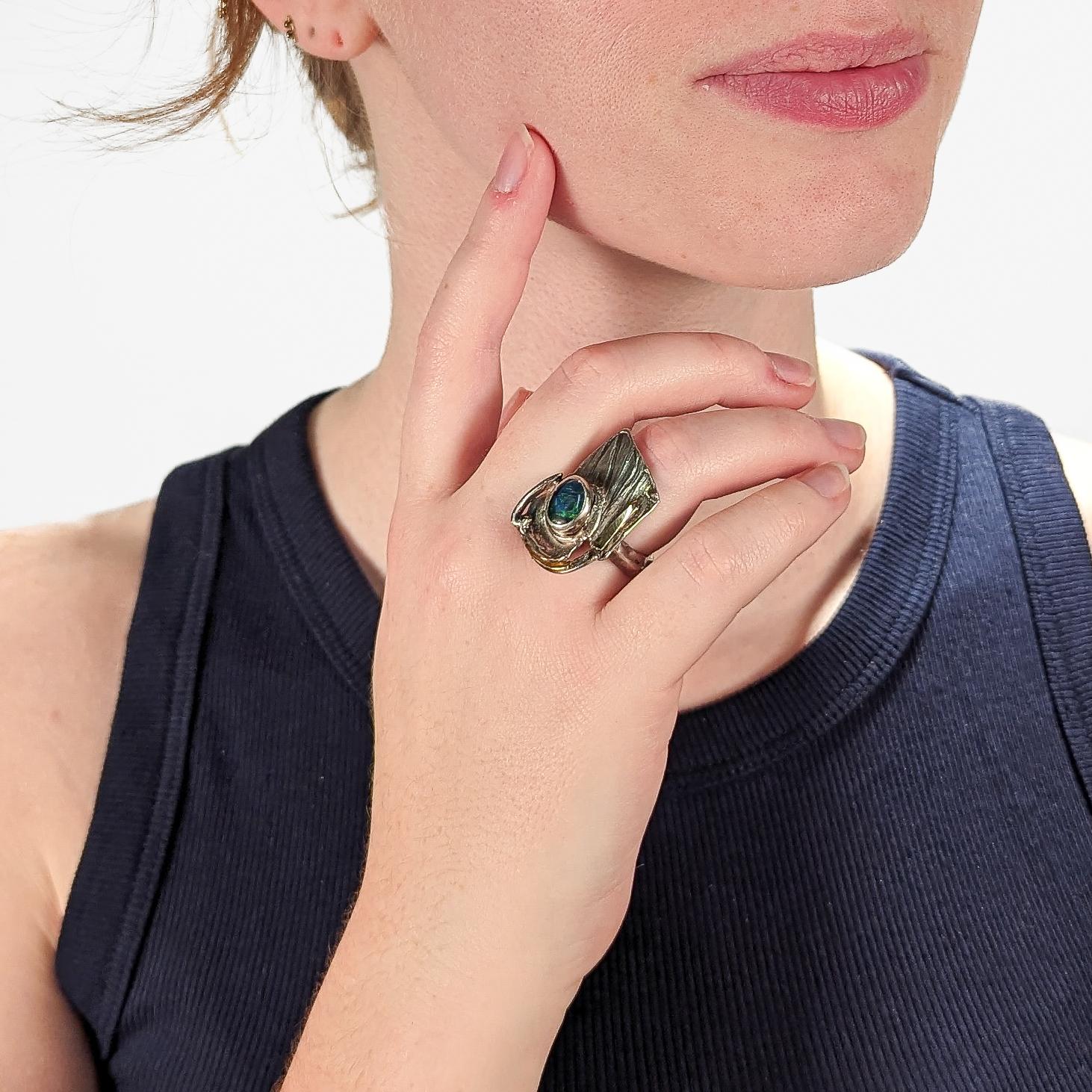 A very fine Glenda Arentzen 14k gold, sterling silver and opal modernist ring.

Consisting of organic geometric textured shapes in sterling silver,  14k gold strips and a bezel set opal at the center. A chunky ring shank matches the top of the