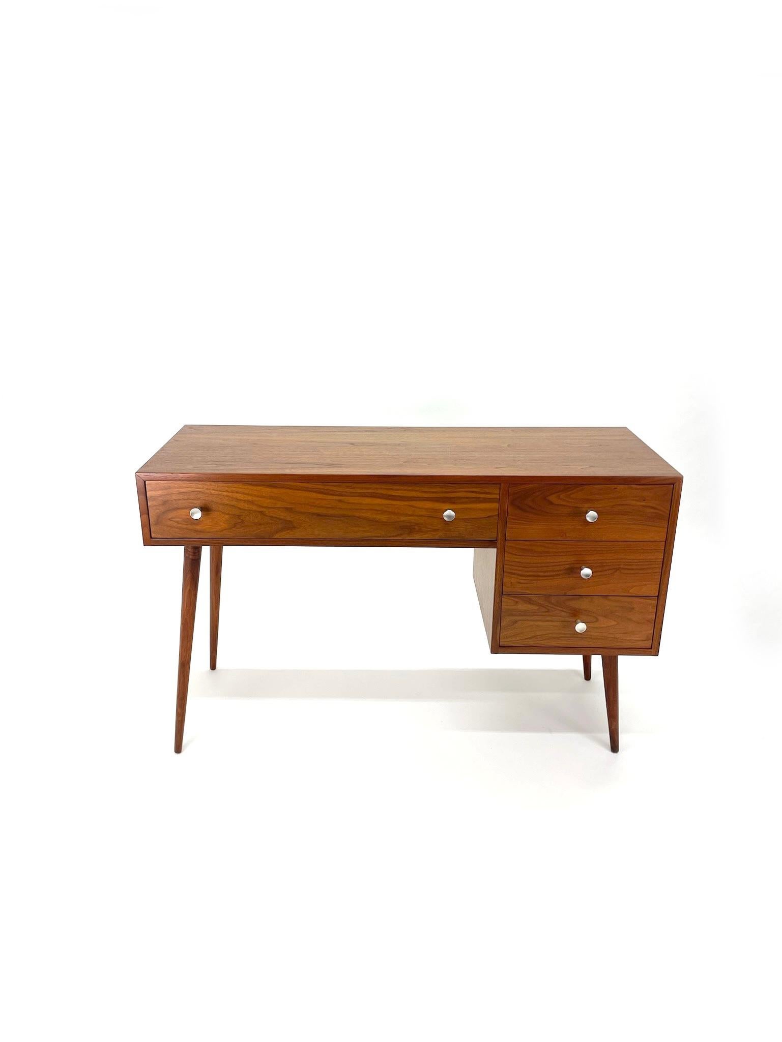 Beautifully restored walnut Glenn of California Desk by Kipp Stewart and Stewart Macdougall. Features four drawers with aluminum pulls. Perfect for a smaller office or bedroom. 

Condition: Has been restored to excellent vintage condition. All