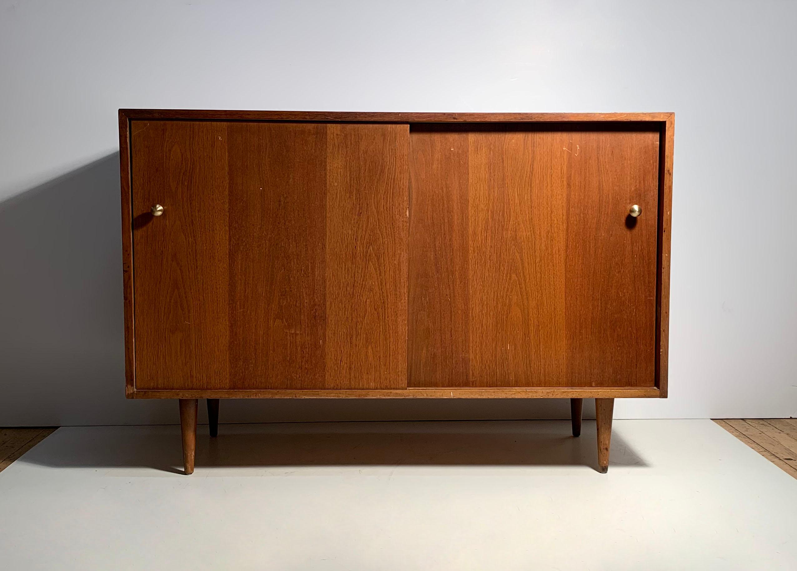 Glenn of California sideboard cabinet designed attributed to Milo Baughman.

Item needs refinishing. Pulls have been replaced with new nice quality brass pulls as shown.