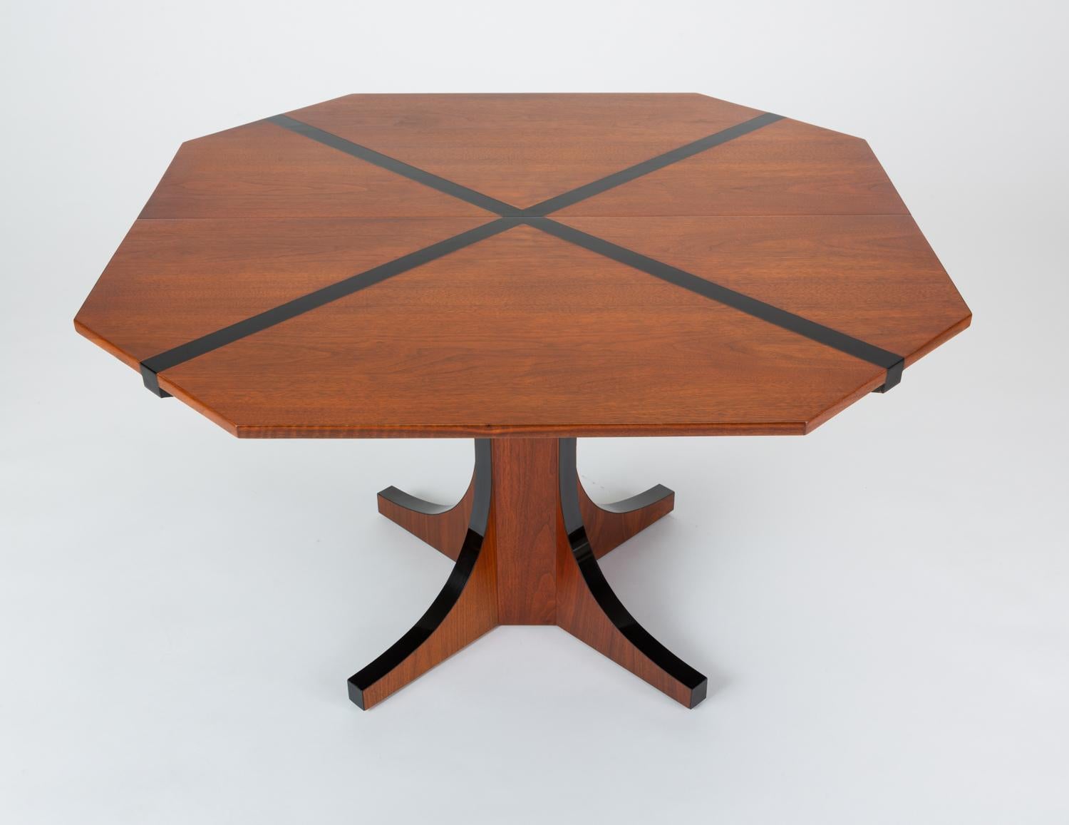 A dining table designed by John Kapel for Glenn of California with a truncated square top inlaid with a black laminate detail in the shape of an 