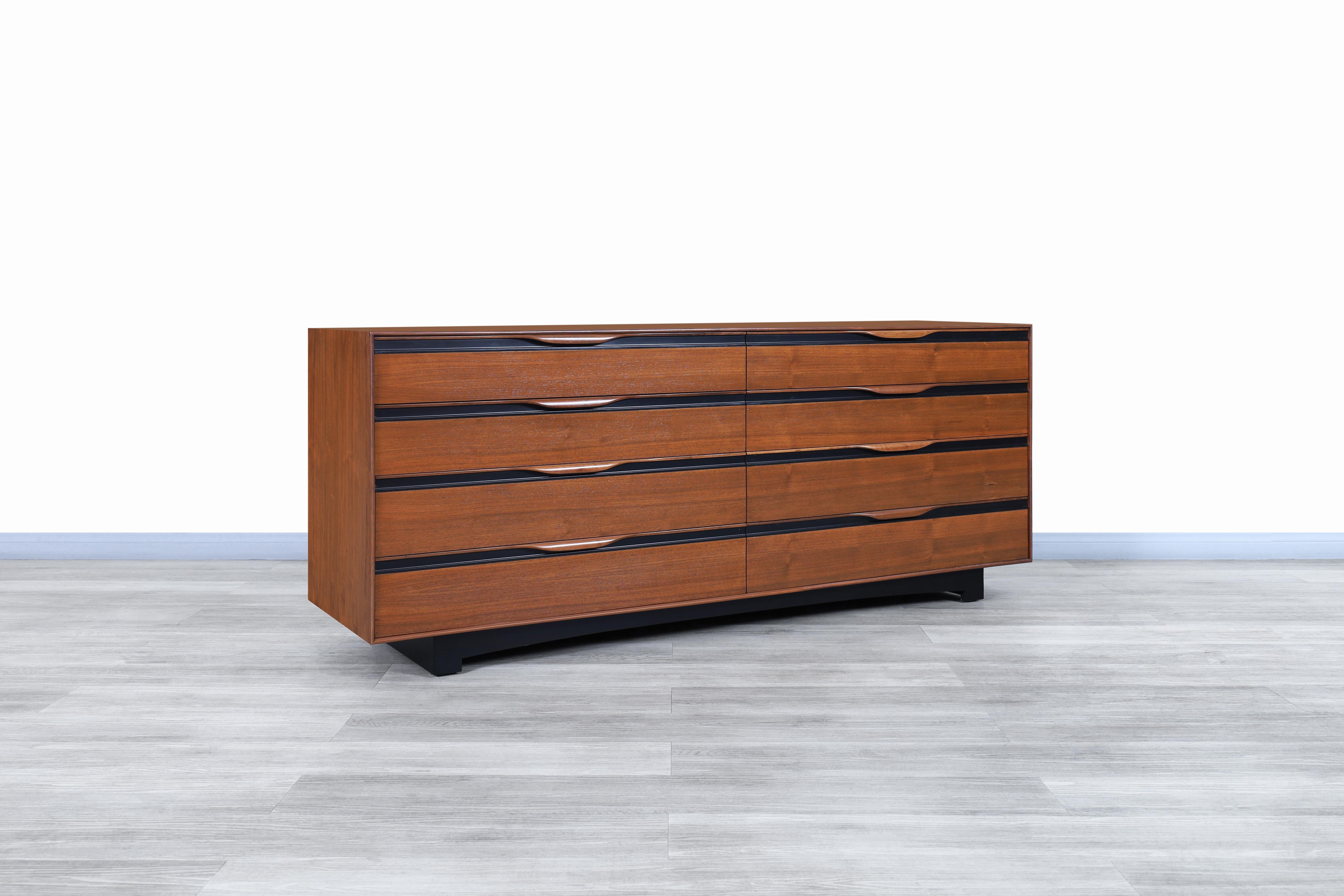 Fabulous vintage walnut dresser designed by John Kapel for Glenn of California in the United States, circa 1950s. This dresser is constructed from fine walnut wood that highlights its beautiful grain. Features a total of 8 large drawers for optimal