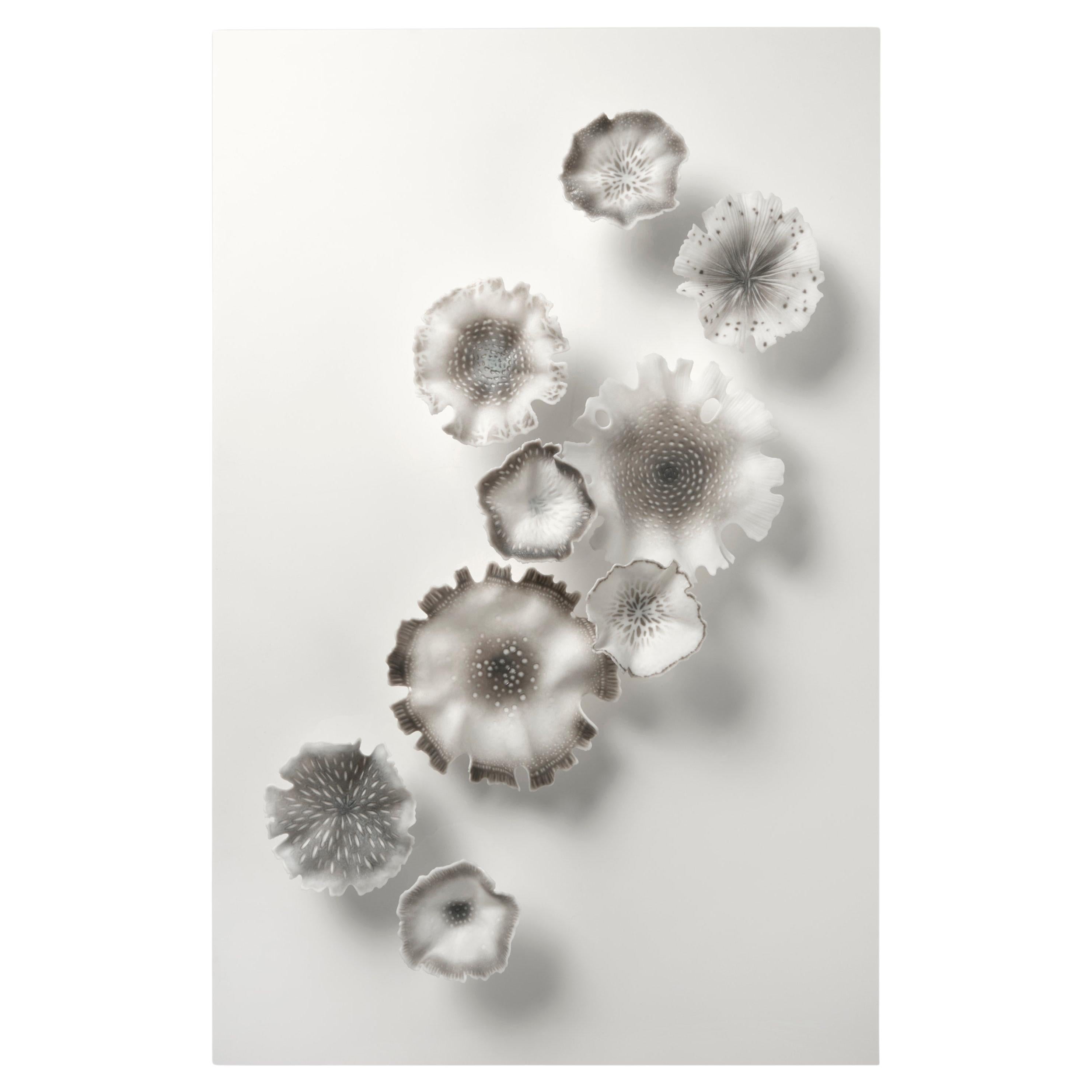 Glimmer in Grey, a floral grey
white glass wall installation by Verity Pulford