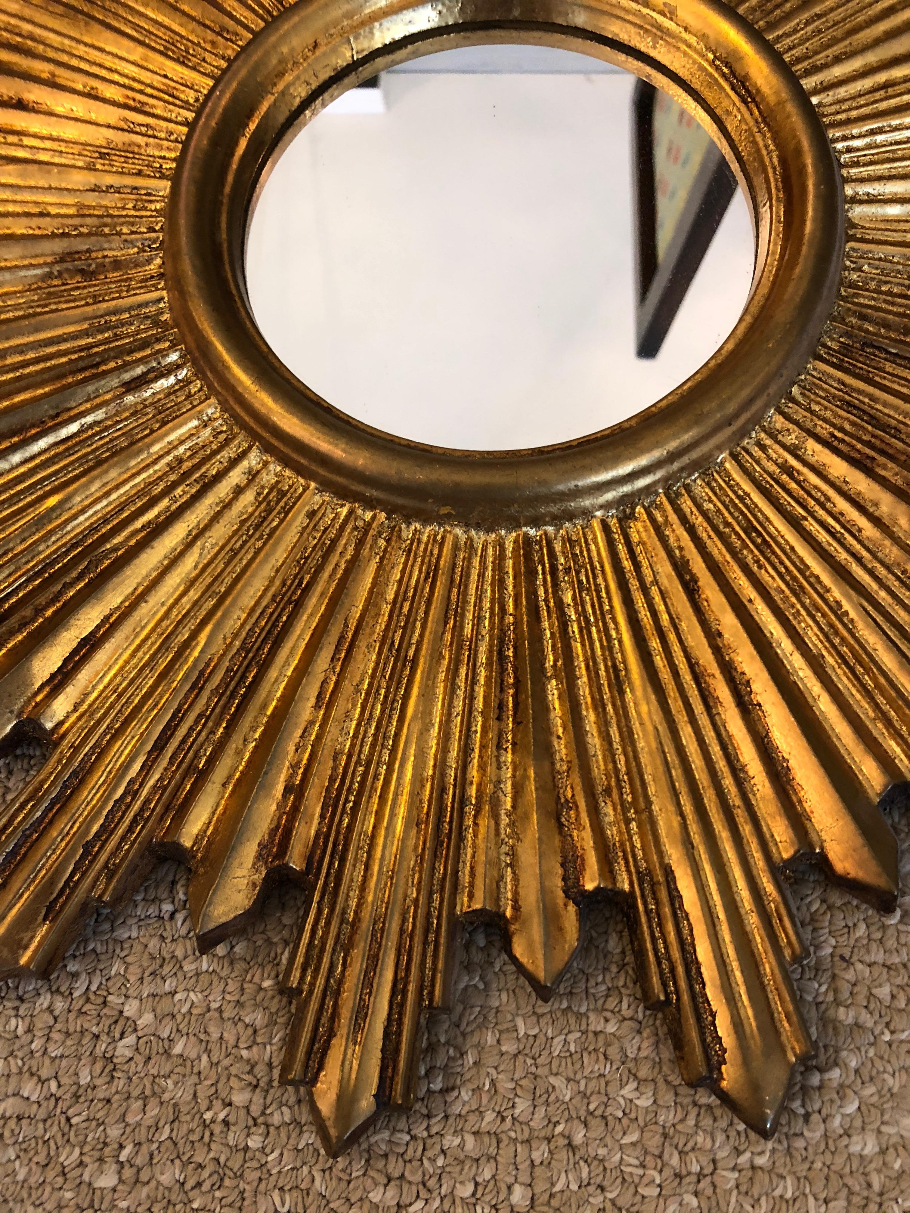 Timeless neoclassical giltwood Italian little sunburst mirror. Measures: Mirror itself is 5 inches diameter.