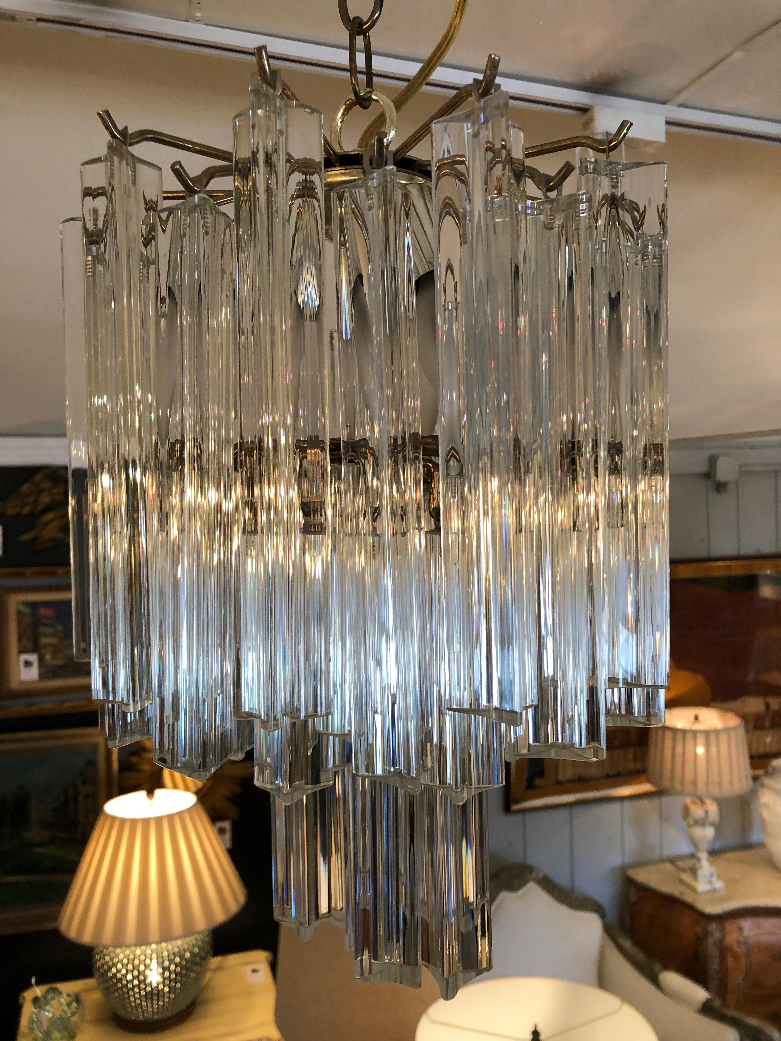 Very glamorous medium sized Venini chandelier having 30 plus glistening rods of glass that hang in varying levels. Super dramatic for a powder room, small foyer or bedroom.
3 candle bulbs, 40 watt each.
