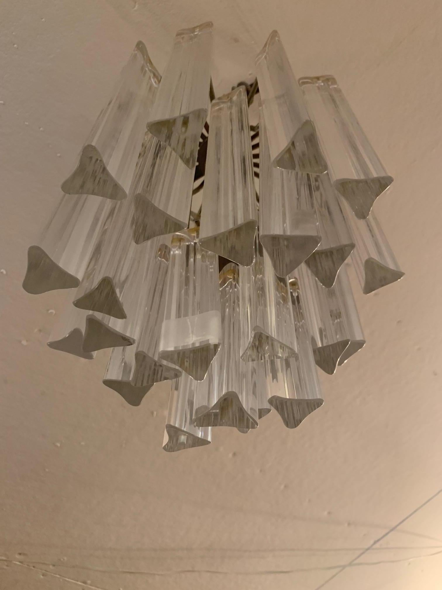 Stylish Mid-Century Modern chandelier having glitzy crystal prism columnar bars.