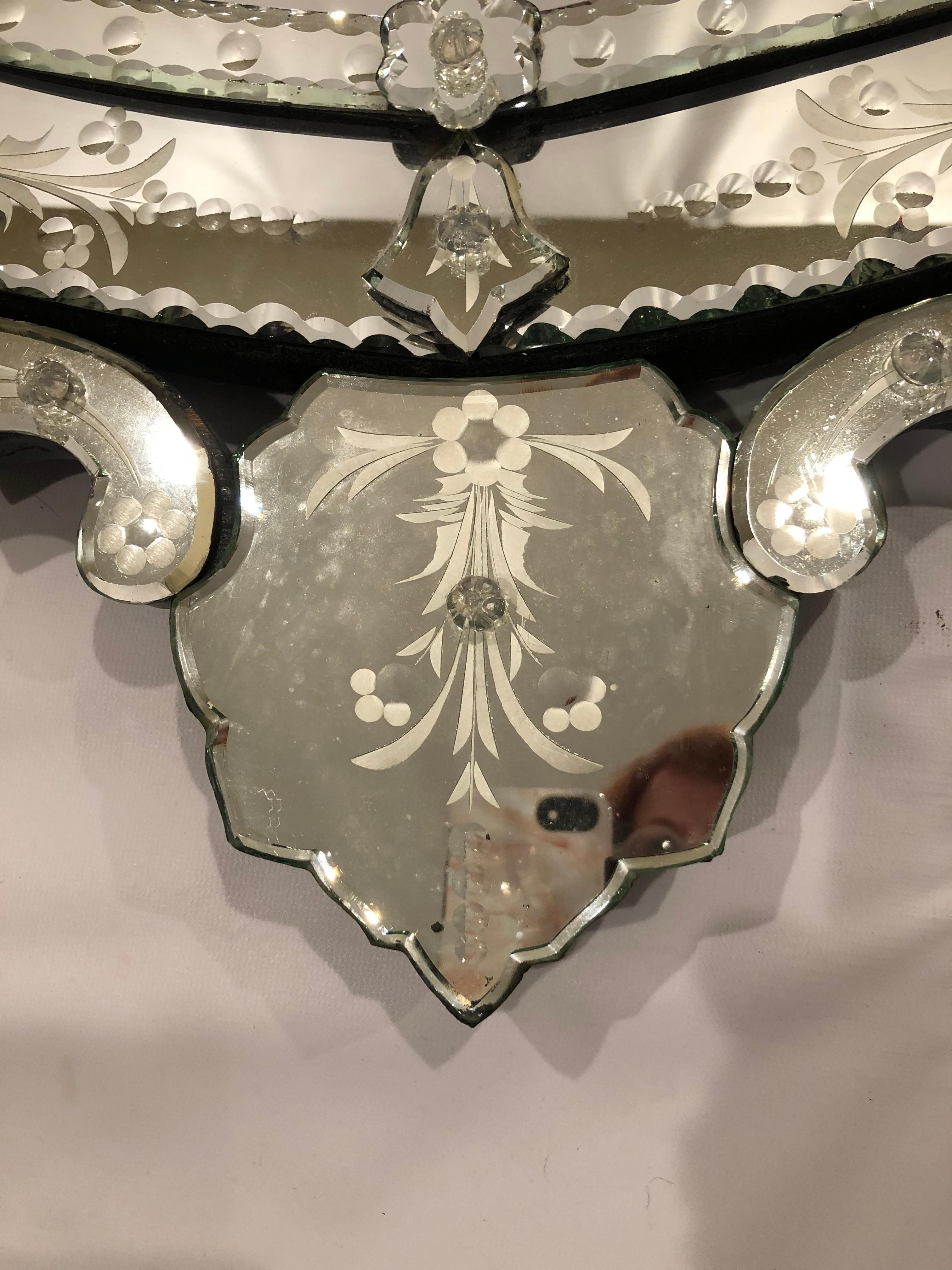 Glamorous pear shaped meticulously detailed Venetian style mirror having ornate crest and lovely etching around the frame.