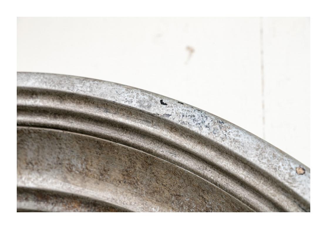 Highly decorative and sophisticated round wall mirror in a mottled silver finish with a prominent moulded frame. Made by Global Views.

Dimensions: 36
