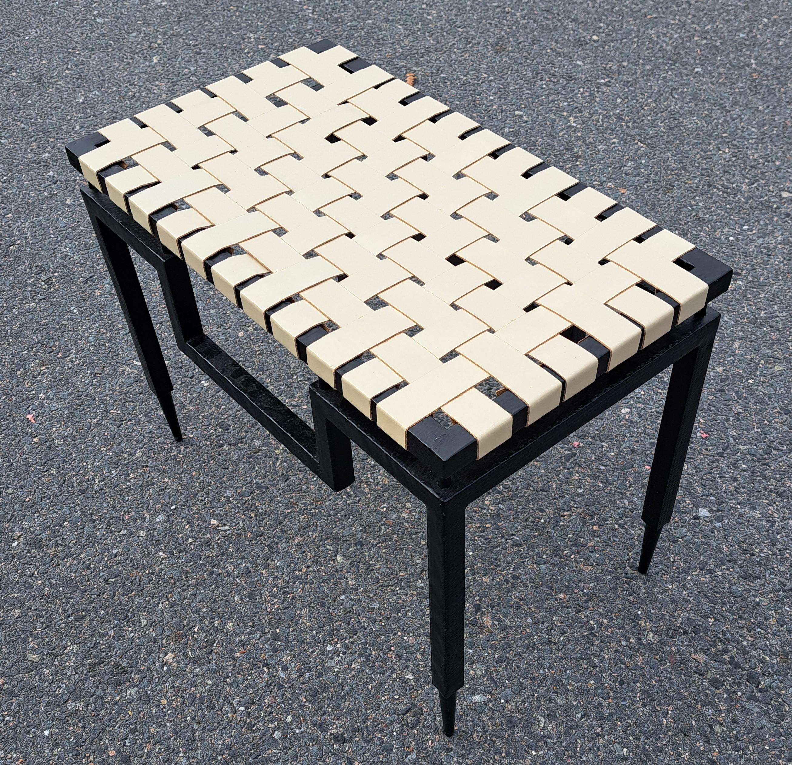 Hand wrought powder coated iron and genuine leather strap bench. With geometric accent.