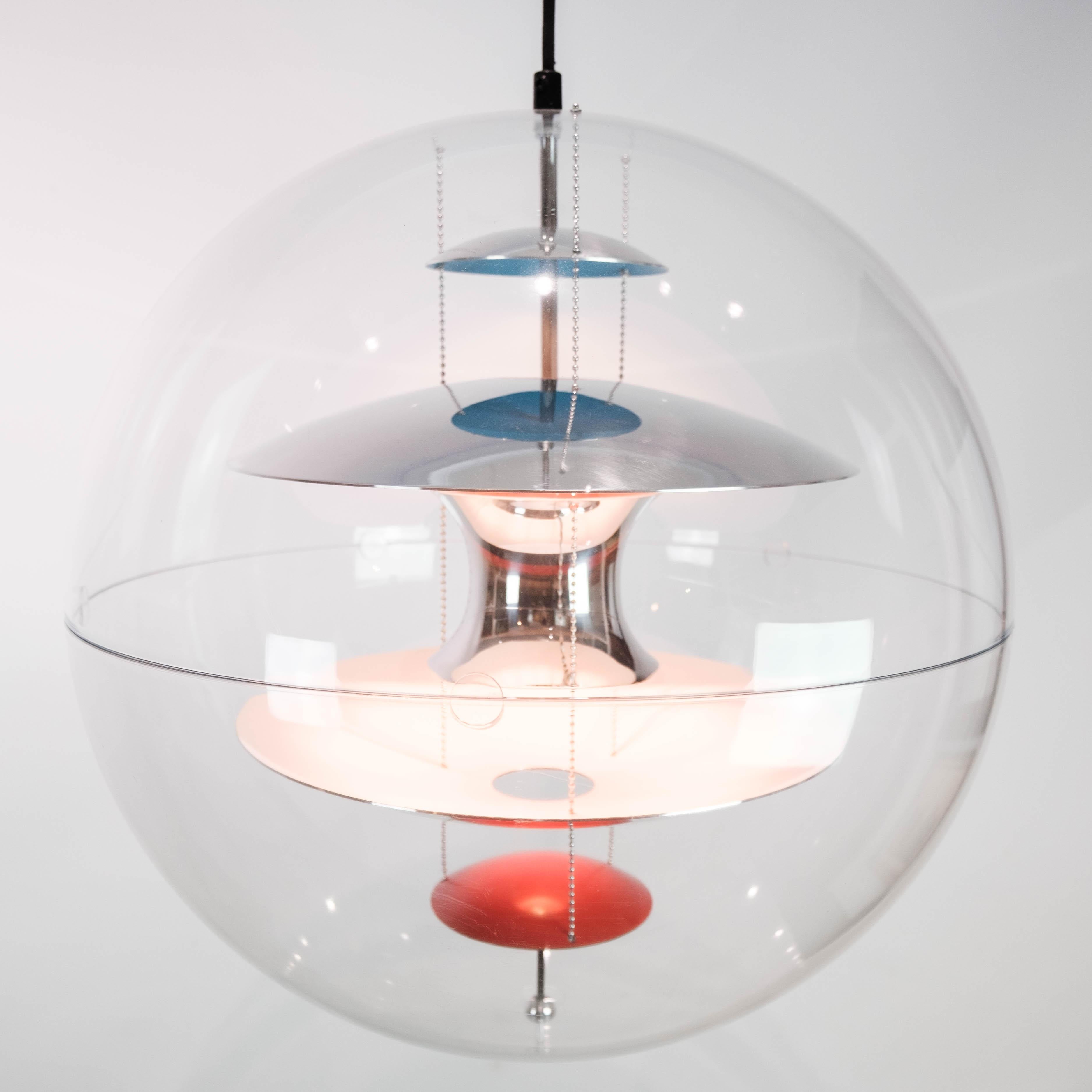 Globe, 50, designed by Verner Panton in 1969. The lamp is a transparent acrylic globe with 5 hanging metal reflectors, which is lacquered in White, blue and red.