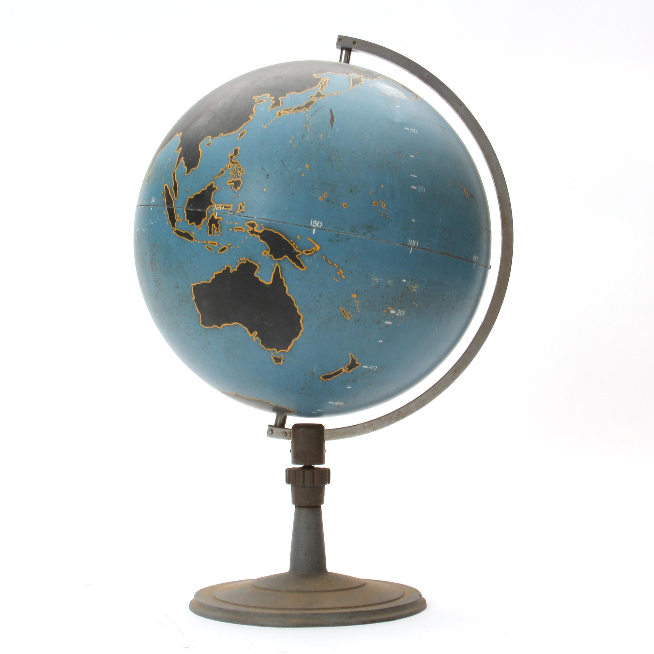 A graphic and finely fabricated spun steel teaching globe mounted on a weighted stand.