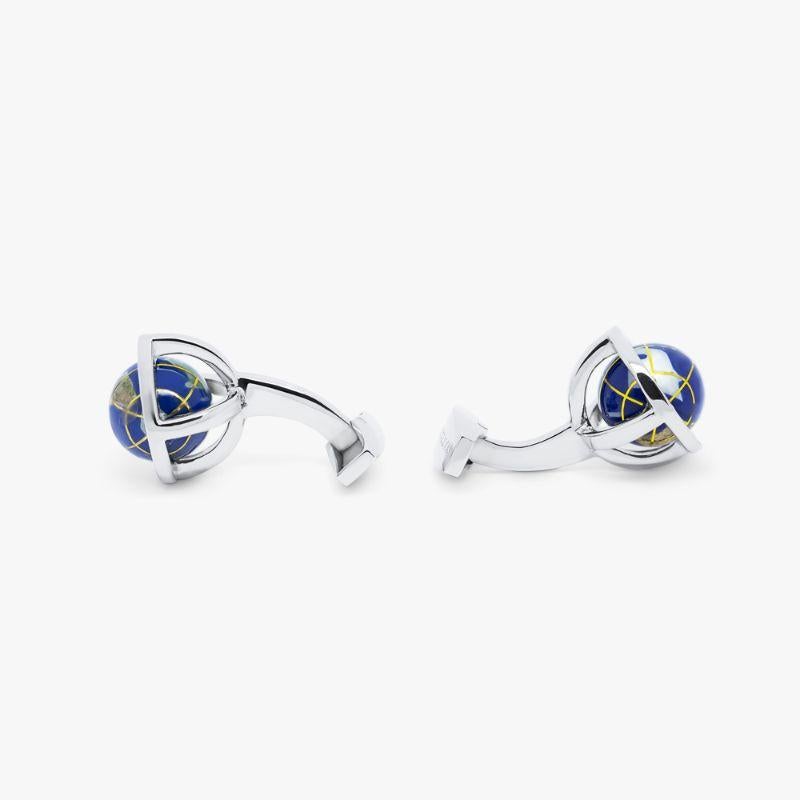 Globe Cufflinks in Lapis and Sterling Silver

Our Iconic Globe cufflinks, which were introduced in 1995, capture a miniature world which rotates by touch. Fitted onto a sterling silver circle cage, the globe is made of infused lapis with latitudinal