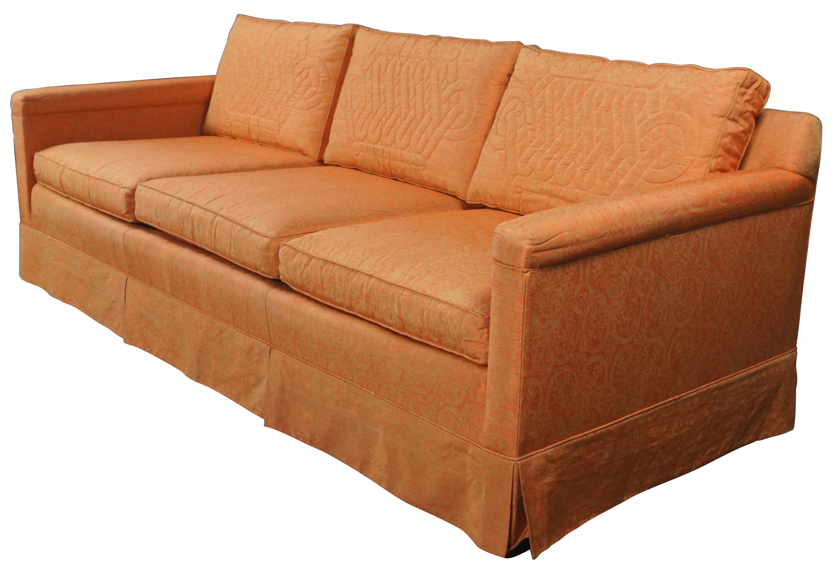 An eye catching mid century 3 seater sofa by Globe Furniture, c.1962. Features a rectangular form upholstered in an orange damask style fabric with quilted medallion back pillows. The sofa is supported by square tapered legs with a mahogany finish.