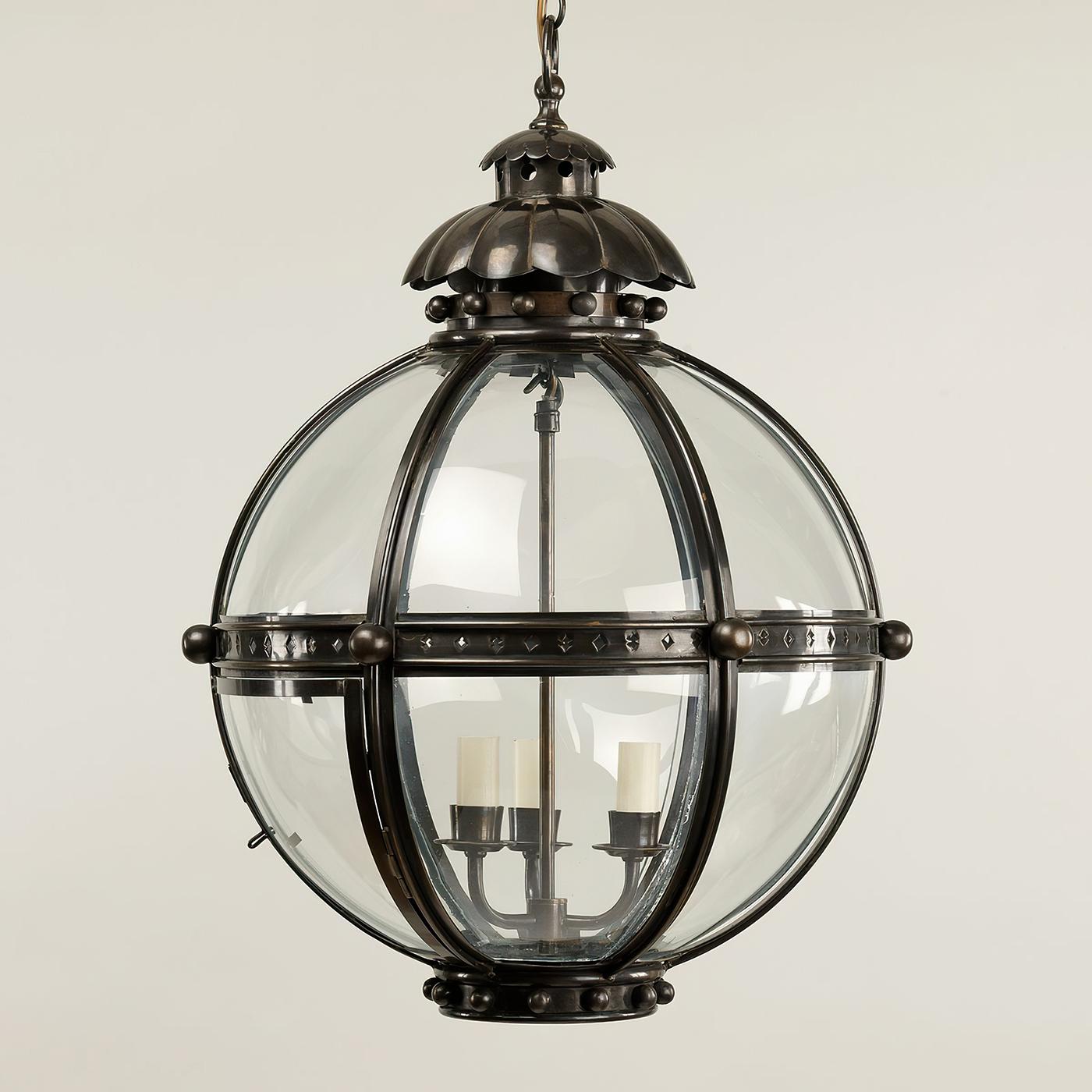 The Globe Lantern is based on a similar 19th-century antique. The globe shape of the fixture emanates strength and is united by the solid bronzed brass finials and acanthus top.

The lantern is hand-fabricated from bronzed brass and curved glass