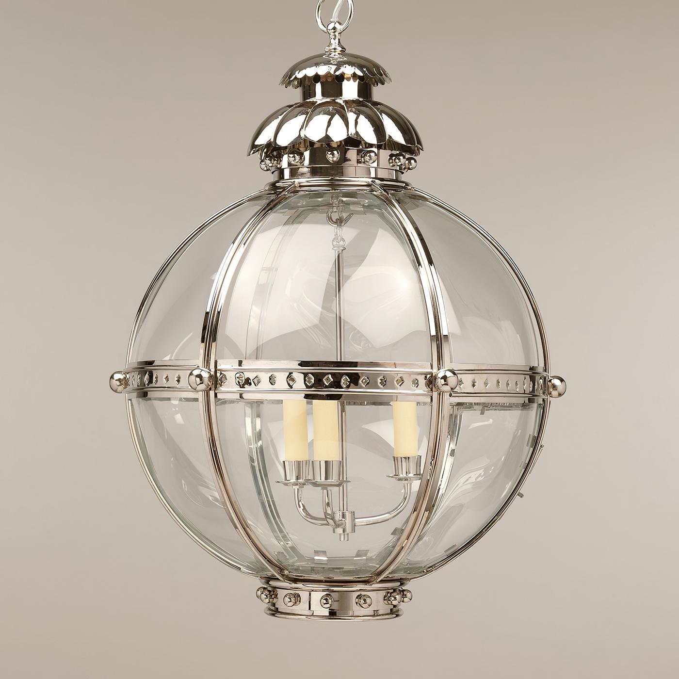 The Globe Lantern is based on a similar 19th-century antique. The globe shape of the fixture emanates strength and is united by the nickel finish finials and acanthus top.

The lantern is hand-fabricated from brass and curved glass panels. The