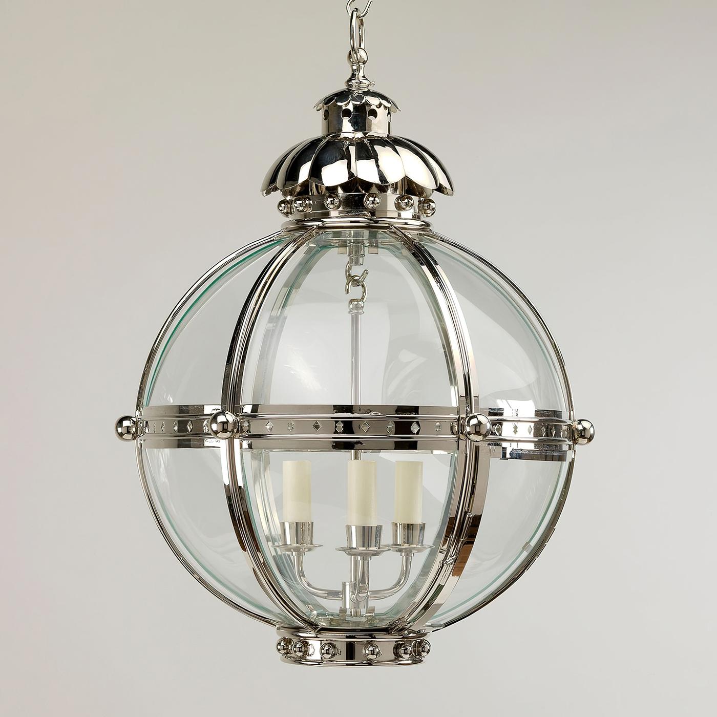 The Globe Lantern is based on a similar 19th-century antique. The globe shape of the fixture emanates strength and is united by the nickel finish finials and acanthus top.

The lantern is hand-fabricated from brass and curved glass panels. The
