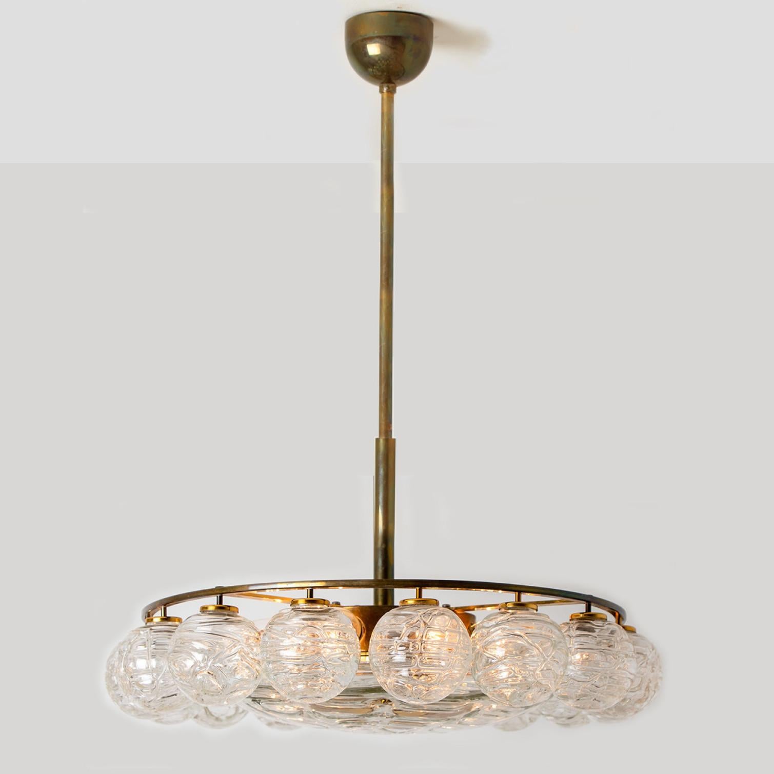 Beautiful chandelier with 16 small glass globes on a brass frame by Doria Leuchten, manufacturered in 1965. With 16 hand blown murano glass globes.

High-end thick Murano crystal glass globes made out of overlay glass applied in irregular swirls.