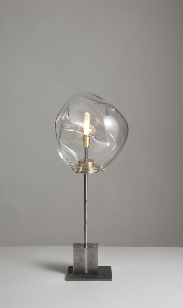 Globe liquid lamp by Sema Topaloglu
Dimensions: 22.5 x 31 x 71.5 cm
Materials: iron, handblown glass

Sema Topaloglu is known for her dedication to materials, craftsmanship and a unique aesthetic vision. The tactile and visual relations between