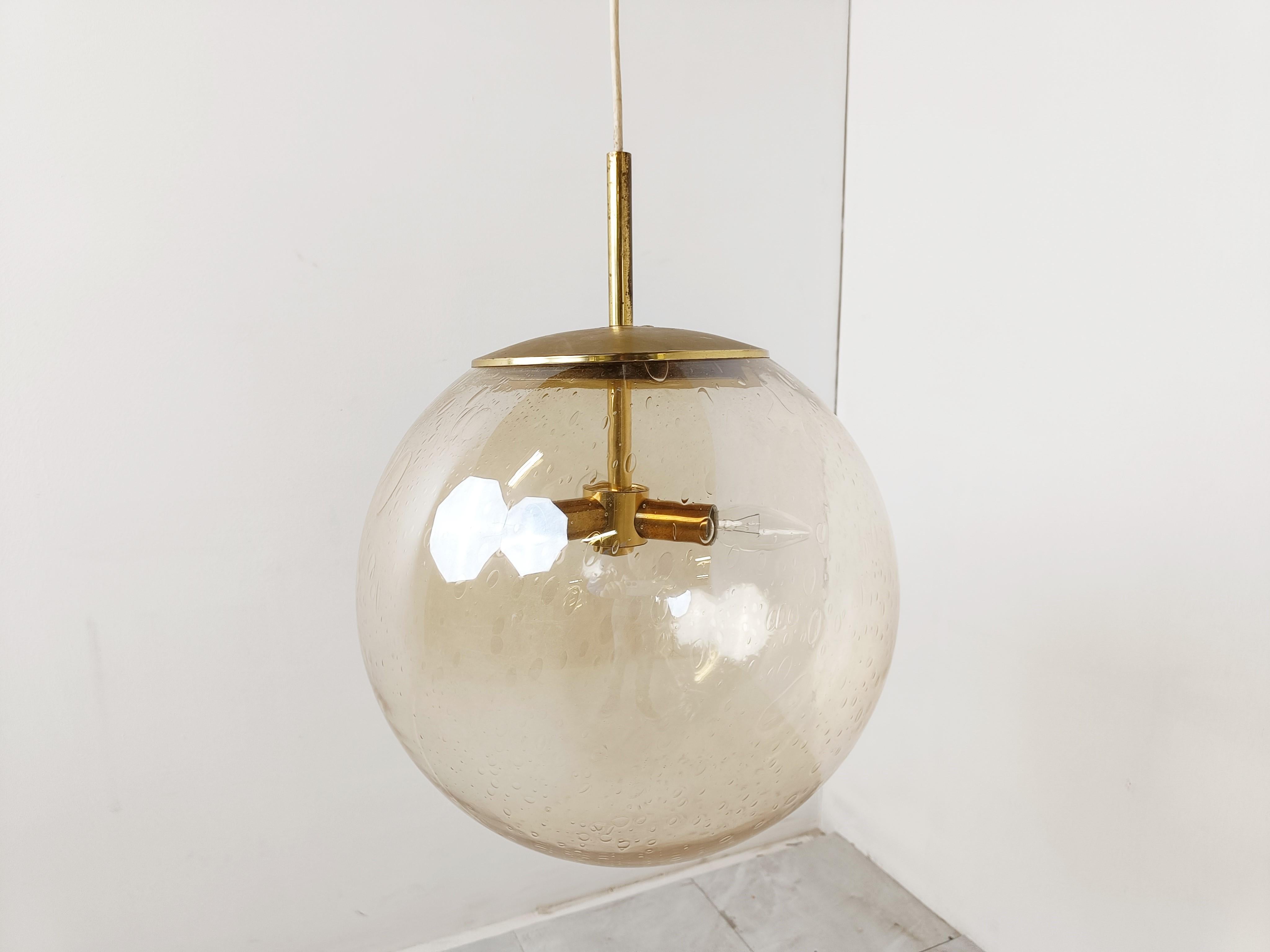 Midcentury glass pendant light by Glashutte Limburg. 

Amber coloured glass which emits a nice light.

Brass sockets and shade holder.

The wire can be lengthened or shortened as desired.

1960s - Germany

Dimensions:
Height: