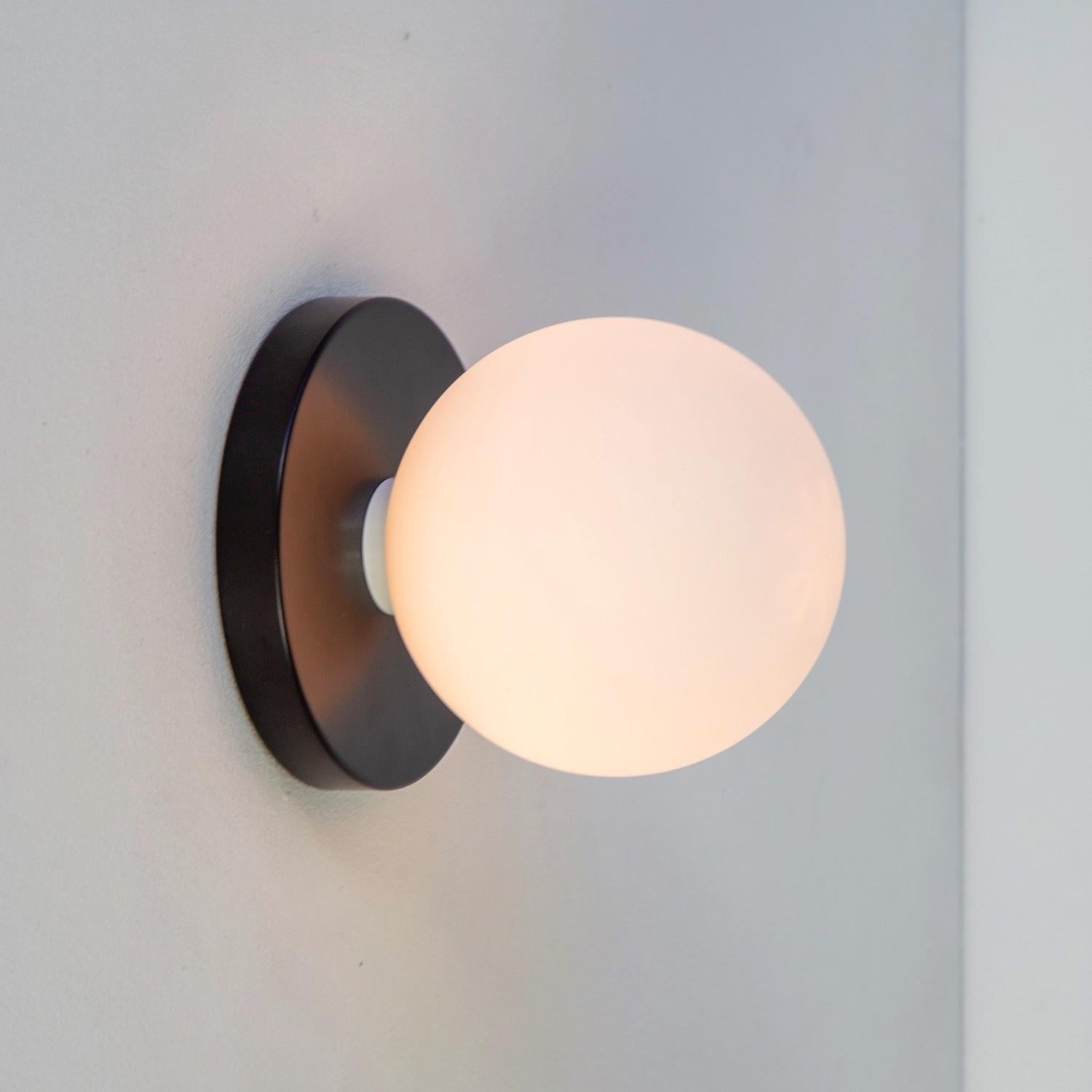 This listing is for 1x Globe Sconce in black designed and manufactured by Research.Lighting.

Materials: Steel & Glass
Finish: Powder-coated steel 
Electronics: 1x G9 Socket, 1x 4.5 Watt LED Bulb (included), 450 Lumens
Globe Diameter: ~4.75in
UL