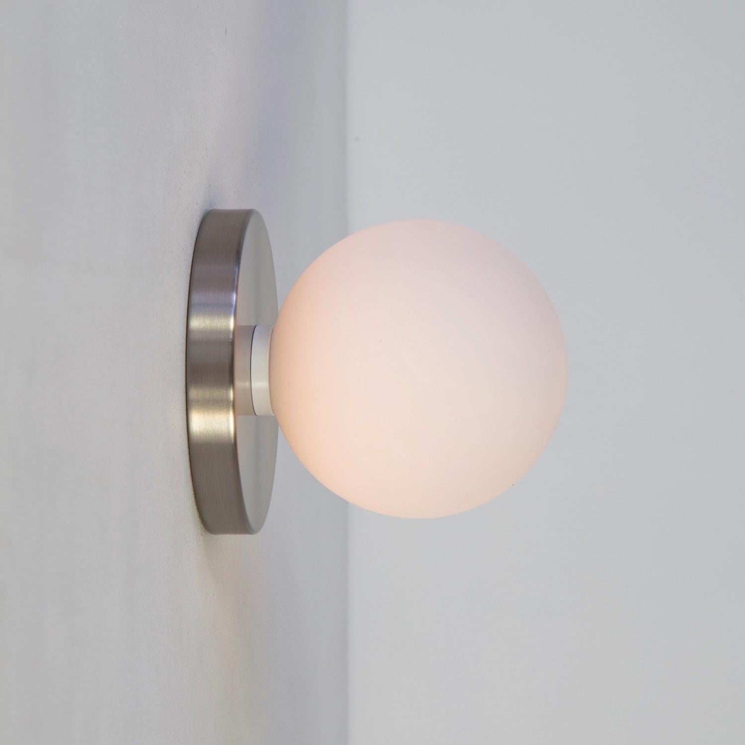 This listing is for 1x Globe Sconce in brushed nickel designed and manufactured by Research.Lighting.

Materials: Brass, Steel & Glass
Finish: Brushed Nickel 
Electronics: 1x G9 Socket, 1x 4.5 Watt LED Bulb (included), 450 Lumens
Globe Diameter: