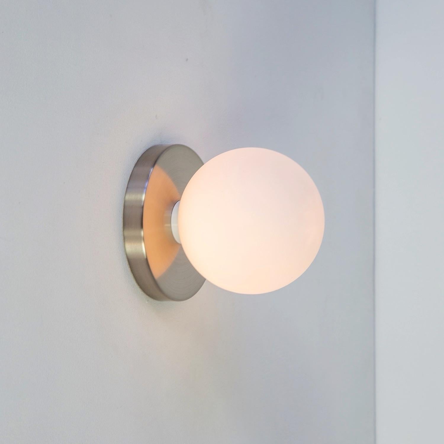 Globe Sconce by Research.Lighting, Brushed Nickel, 5in Glass, In Stock In New Condition For Sale In Brooklyn, NY