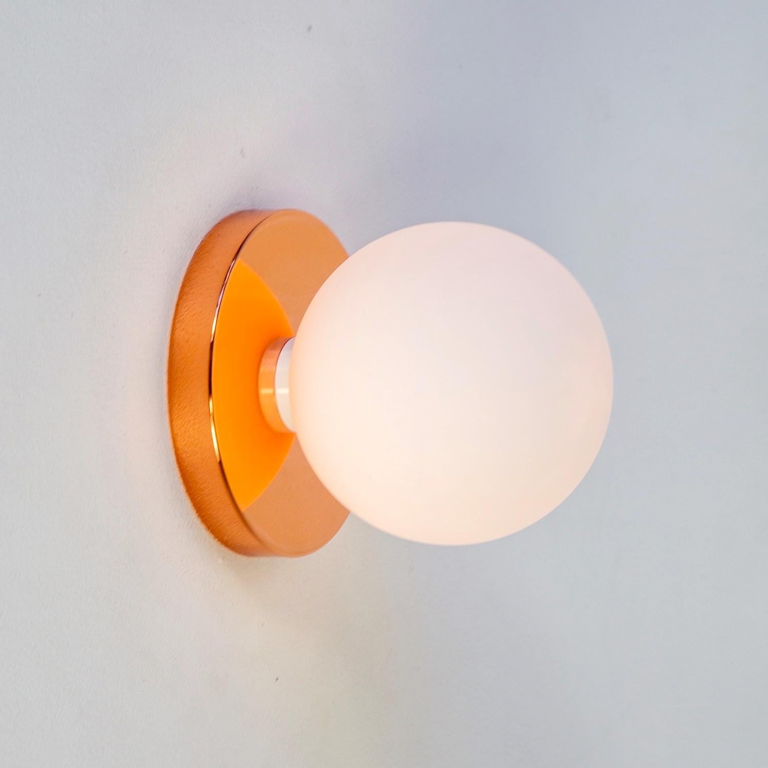 This listing is for 1x Globe Sconce in polished copper designed and manufactured by Research.Lighting.

Materials: Brass, Steel & Glass
Finish: Polished Copper 
Electronics: 1x G9 Socket, 1x 4.5 Watt LED Bulb (included), 450 Lumens
Globe Diameter: