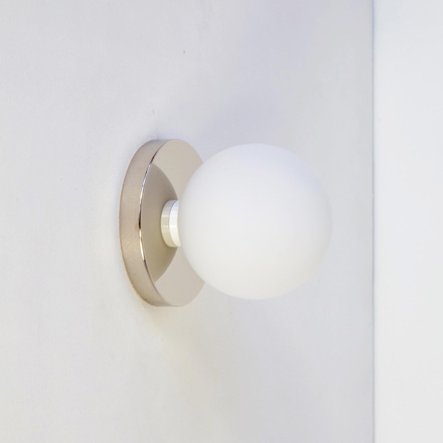 This listing is for 1x Globe Sconce in polished nickel designed and manufactured by Research.Lighting.

Materials: Brass, Steel & Glass
Finish: Polished Nickel 
Electronics: 1x G9 Socket, 1x 4.5 Watt LED Bulb (included), 450 Lumens
Globe Diameter: