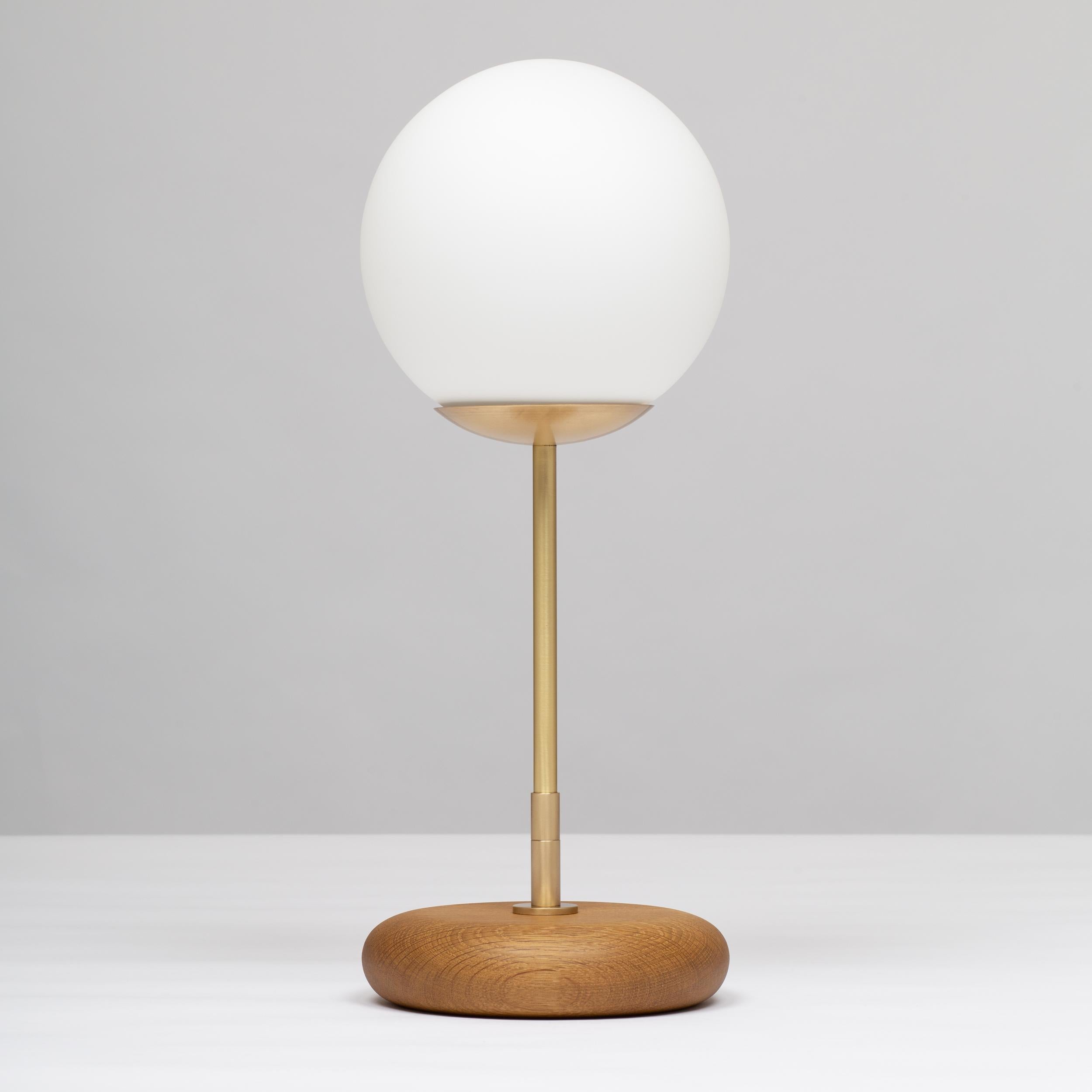 Handturned English Smoked Oak Pebble Table Lamp. Pure Monocoat natural oil finish.
Solid brass, Satin finish. Spun Brass Disc. Lacquered. 
Inline LED dimmer. Linen Fabric Cable.
Candle 360 Lumens | 2500K | 95CRI
or Light Engine 1000 Lumens | 2200K -