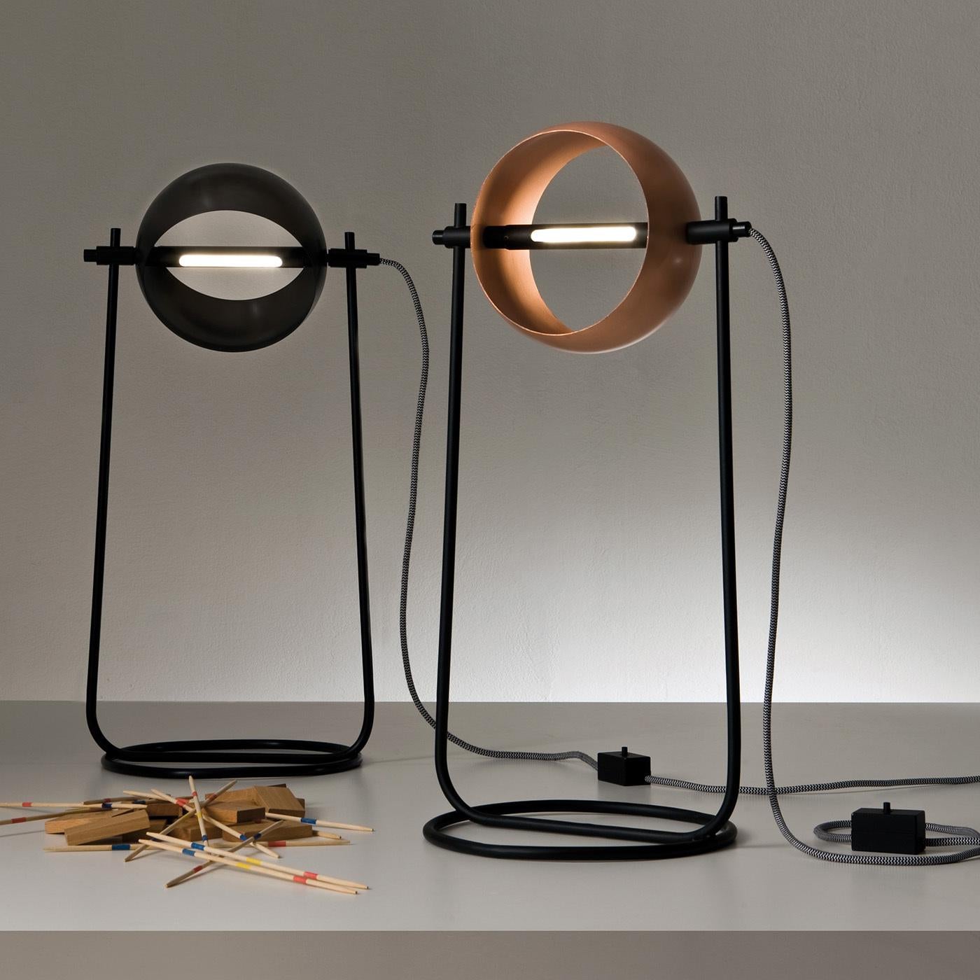 This smaller version of Colzani's striking Globe design features an original metal-crafting technique combined with a functional, central LED 3000K light strip and a superbly ingenious rotating lampshade. Featured with a black iron base and