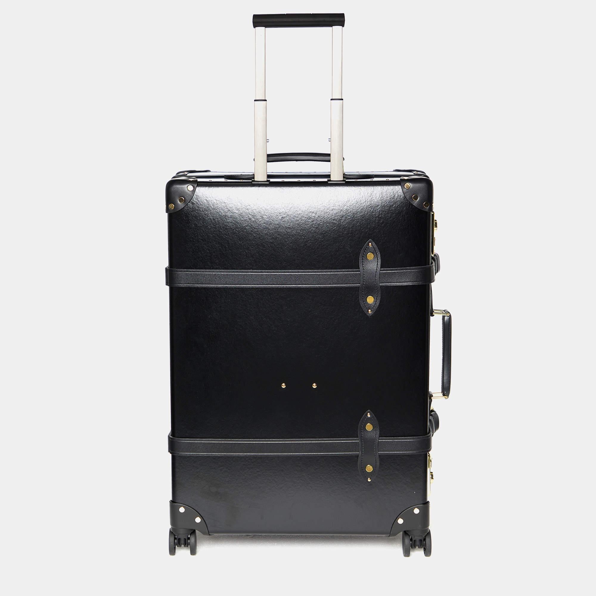Globe-Trotter calls it 'an essential companion' for your travels. The Centenary luggage case is made of vulcanized fibreboard and the body is aided by leather and gold-tone hardware. It has a structured shape with leather handles, a telescopic cane,