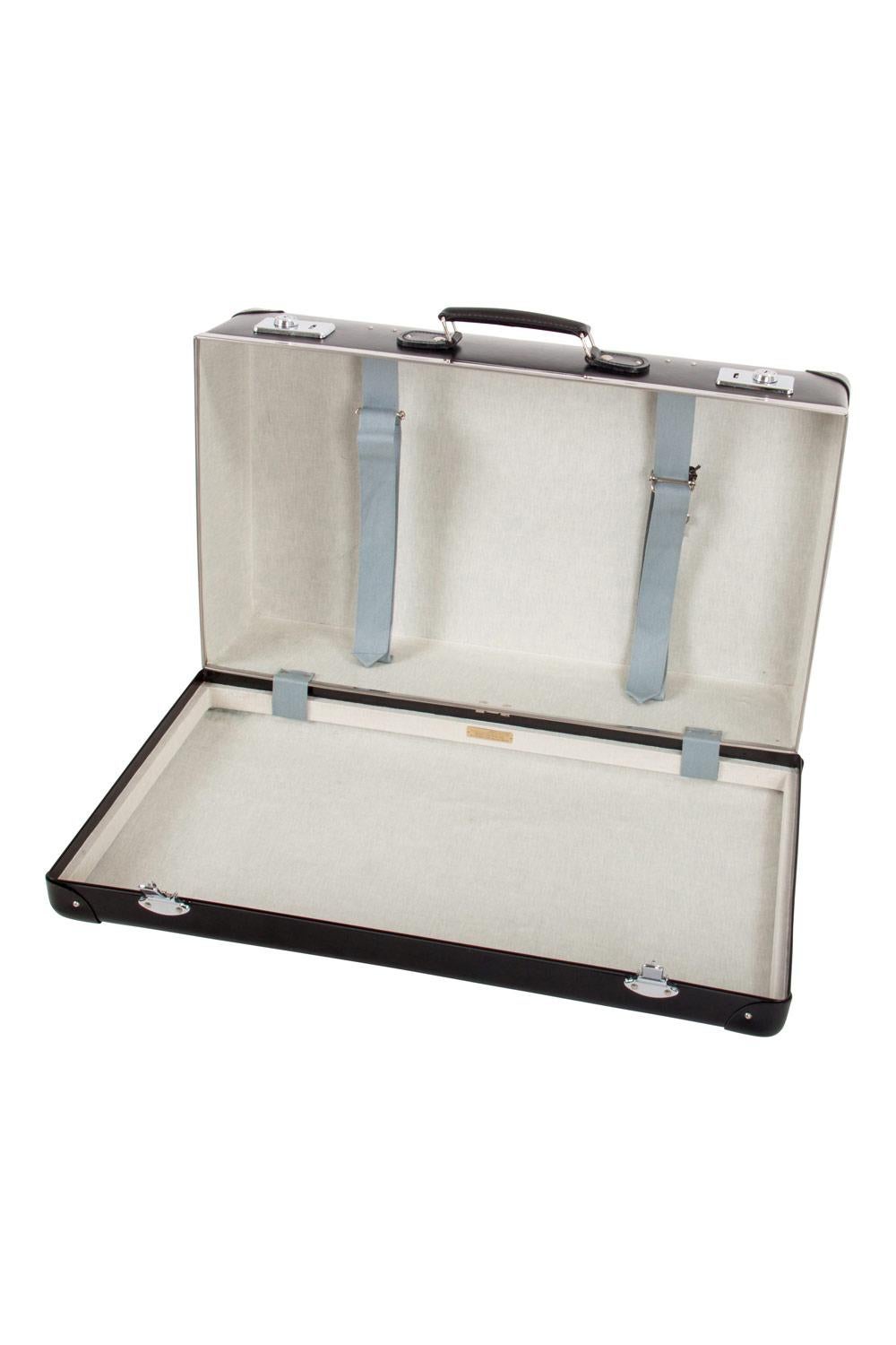 Travel in lavish luxury and unmatched style with this stunning Globe-Trotter luggage case. Designed in plastic and leather, the case has armoured corners and a key lock which adds a vintage touch. The spacious interior is lined with canvas and the