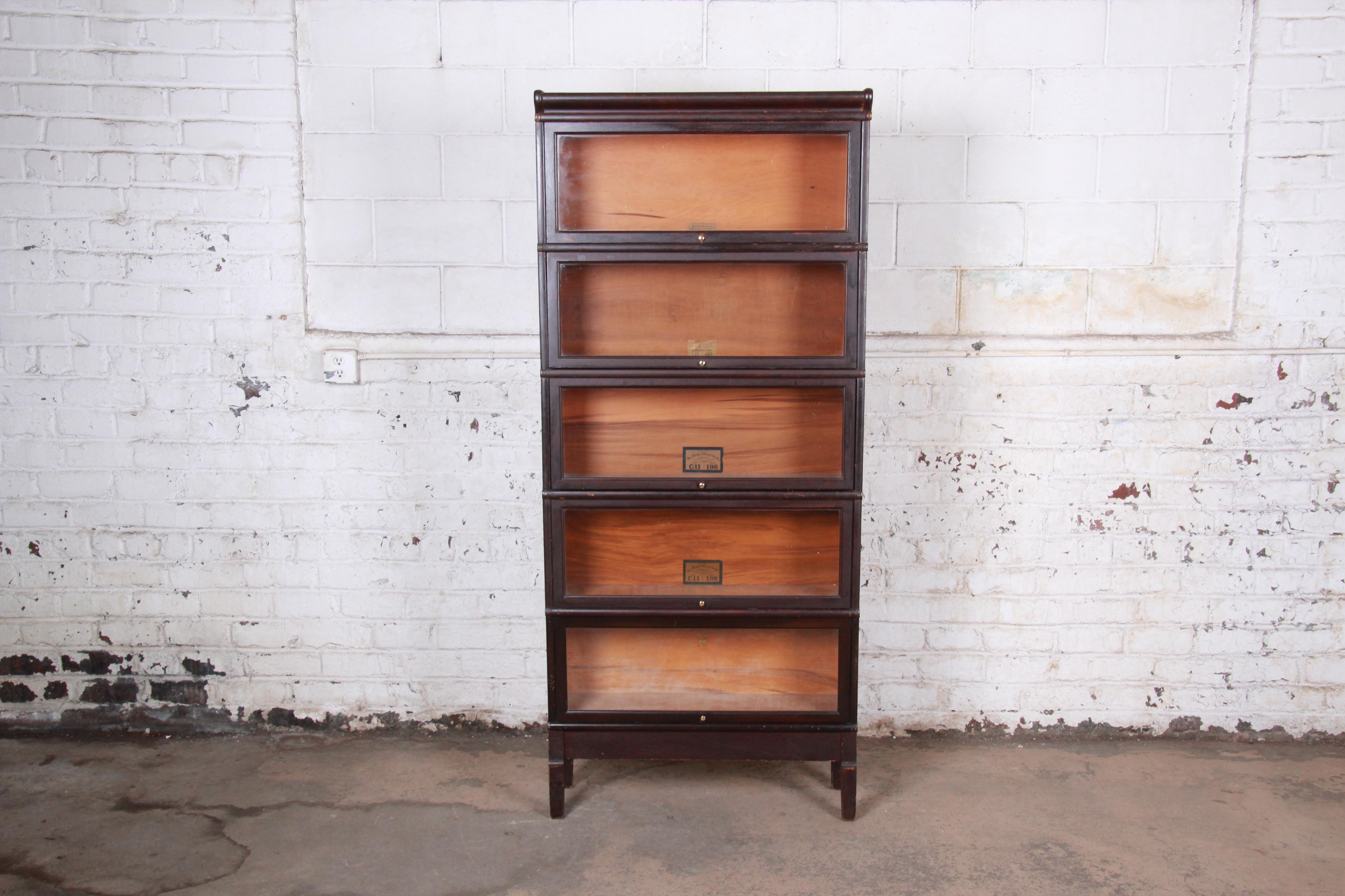 A gorgeous antique five-stack barrister bookcase

By Globe-Wernicke

USA, circa 1920s

Stained oak and glass and brass hardware

Measures: 34.13
