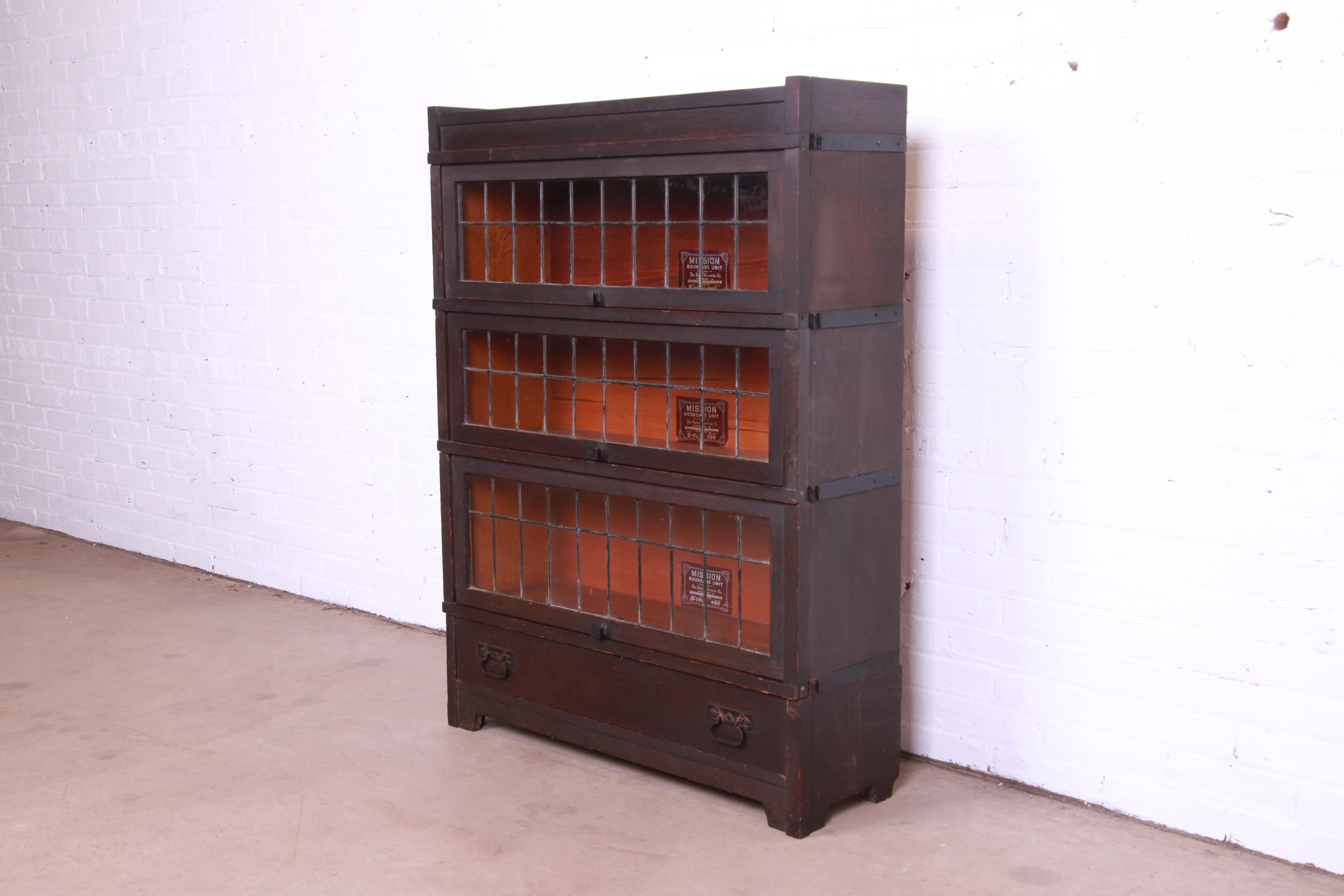 A gorgeous antique Mission oak Arts & Crafts three-stack barrister bookcase with leaded glass

By Globe Wernicke

USA, Circa 1900

Oak, with leaded glass front doors.

Measures: 36.75