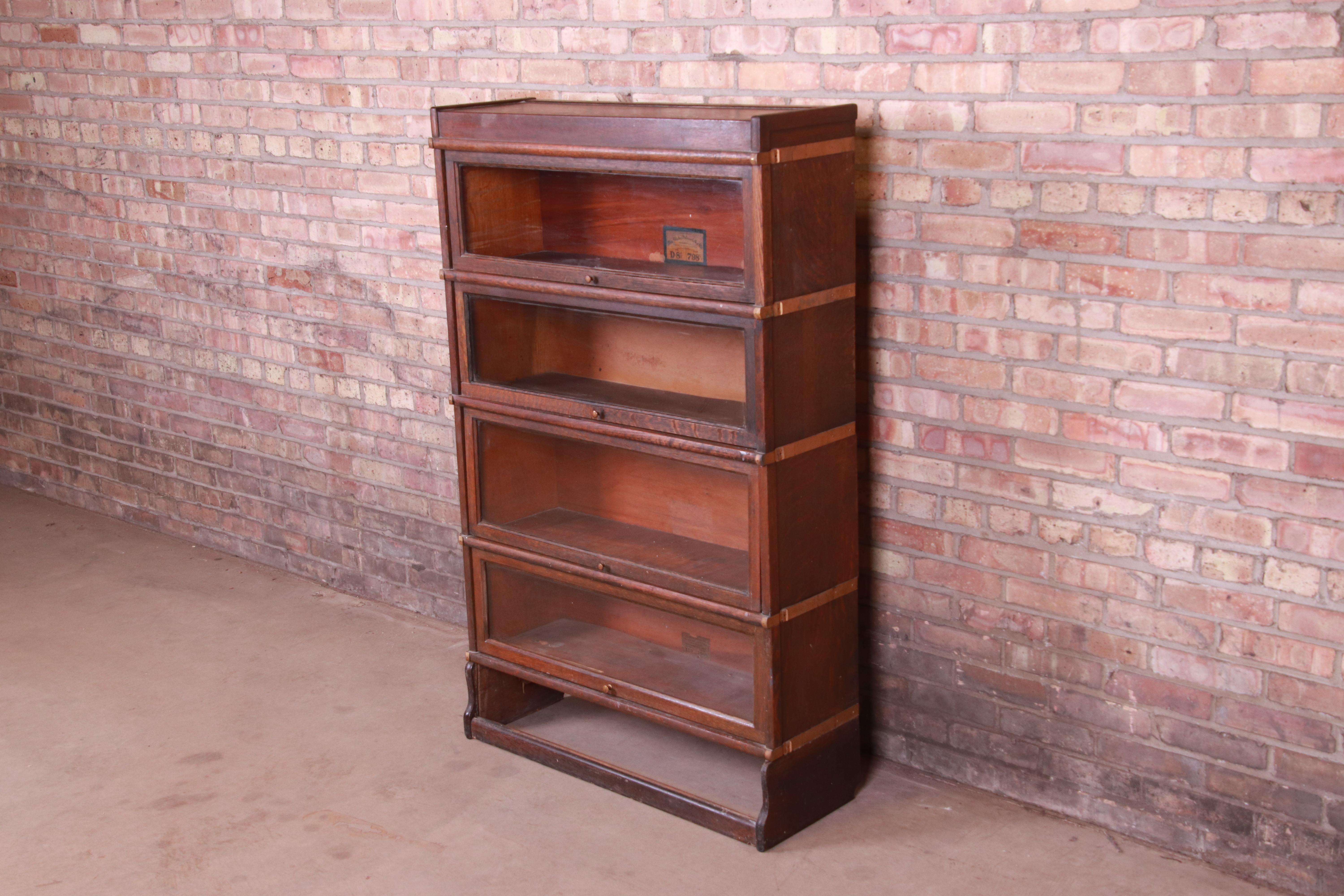 A gorgeous antique Arts & Crafts four-stack barrister bookcase

By Globe Wernicke

USA, circa 1920s

Quartersawn oak, with original brass hardware and glass door fronts.

Measures: 34