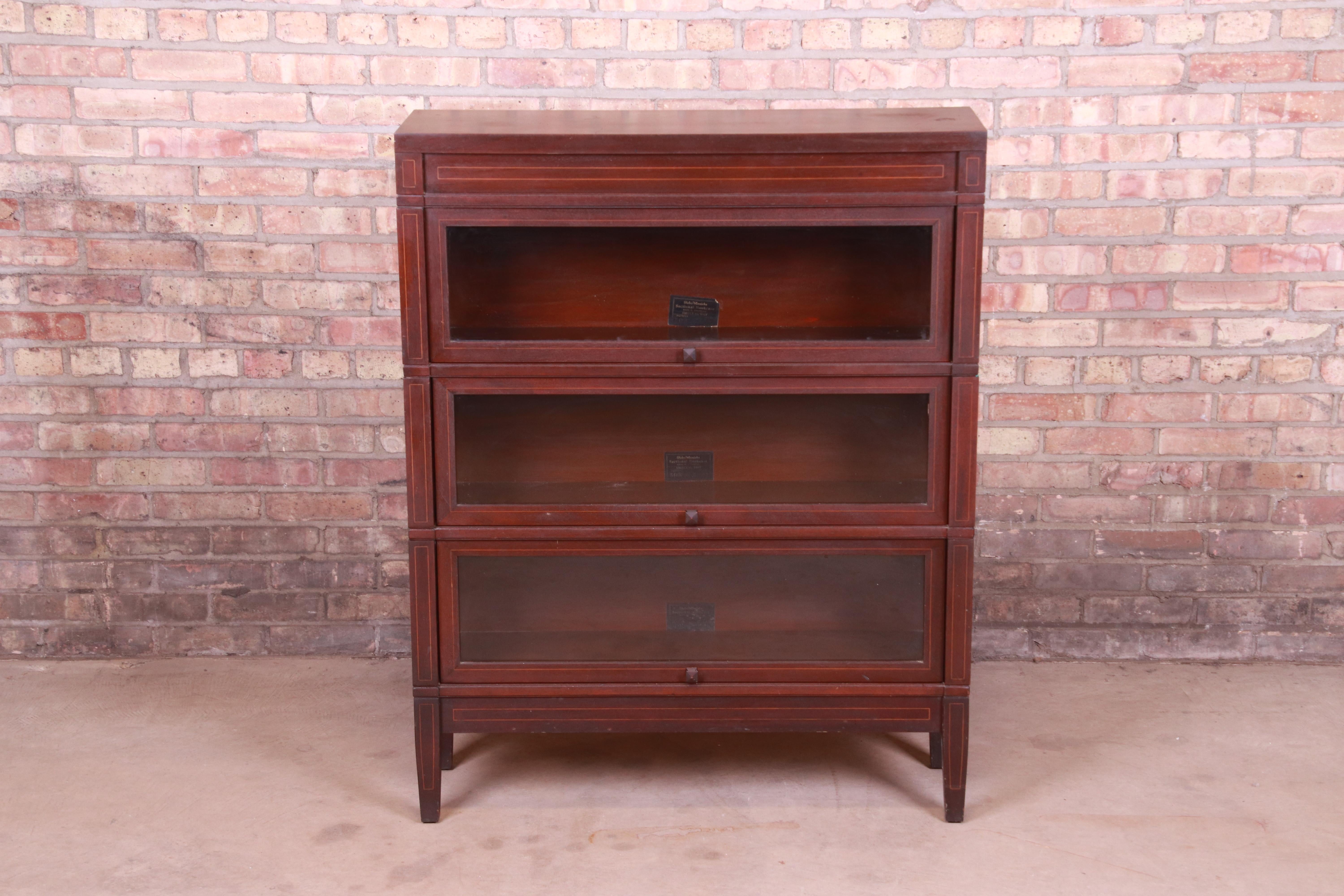 A gorgeous antique three-stack barrister bookcase

By Globe Wernicke,

USA, circa 1920s

Mahogany, with satinwood string inlay and glass front doors.

Measures: 35.63