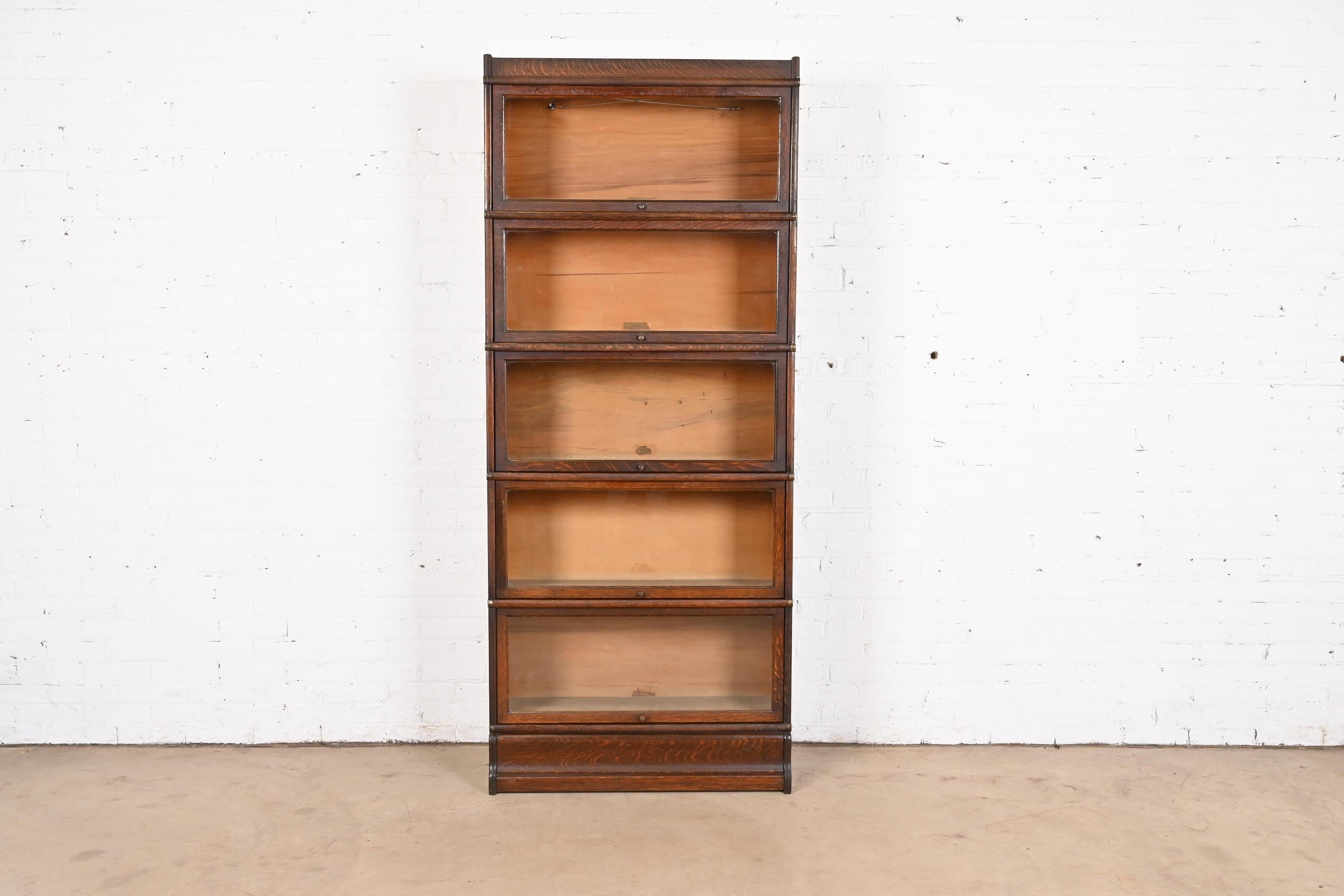 A gorgeous antique Arts & Crafts five-stack barrister bookcase

By Globe Wernicke

USA, Circa 1920s

Quartersawn oak, with original brass hardware and glass door fronts.

Measures: 34