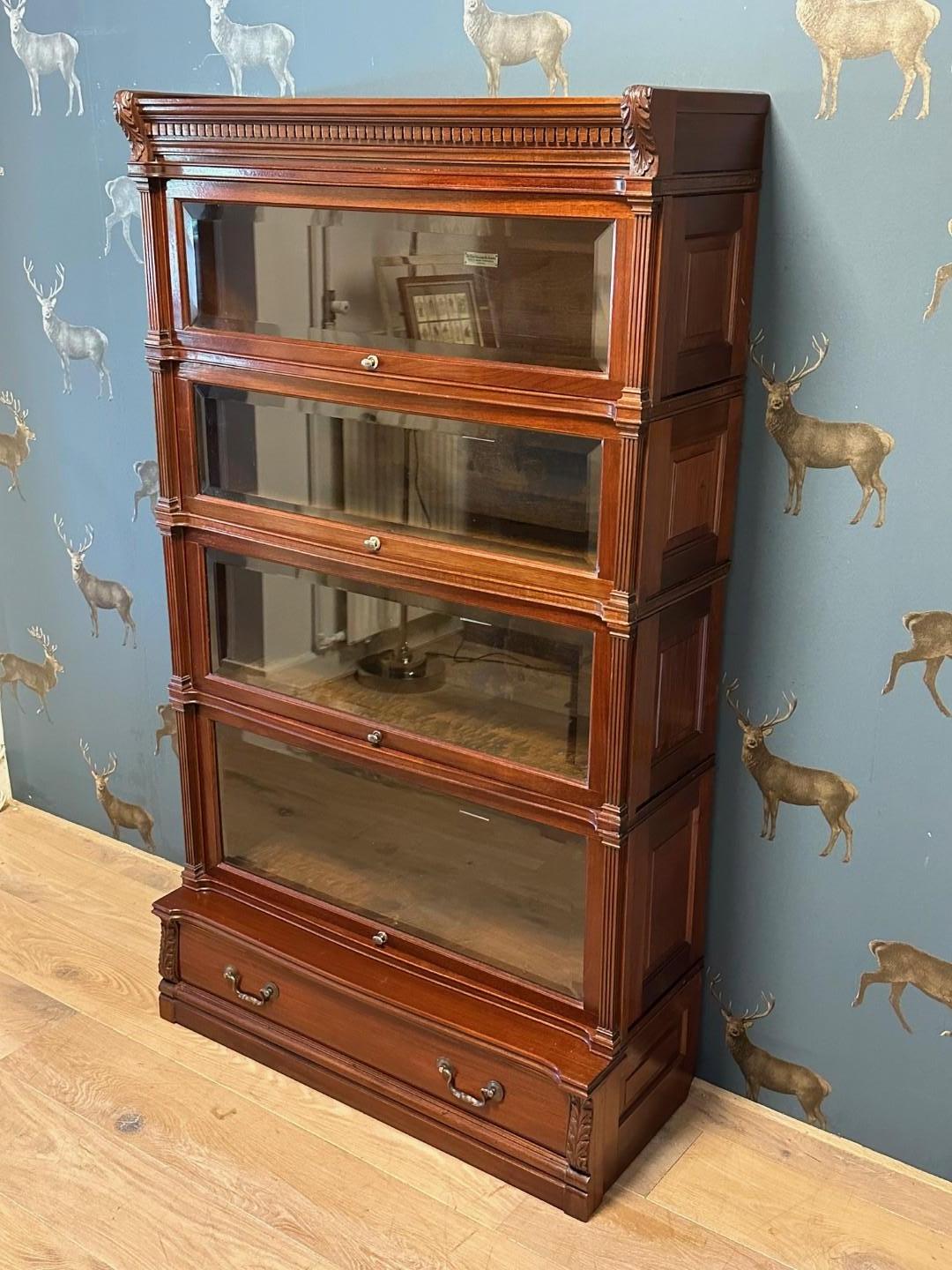 Antique Globe Wernicke bookcase in very good condition. This is the most special version of the Globe Wernicke bookcases. Beautiful details with rich decoration and cut glass. also a drawer in the plinth. Beautiful warm color. Cabinet Consists of 6