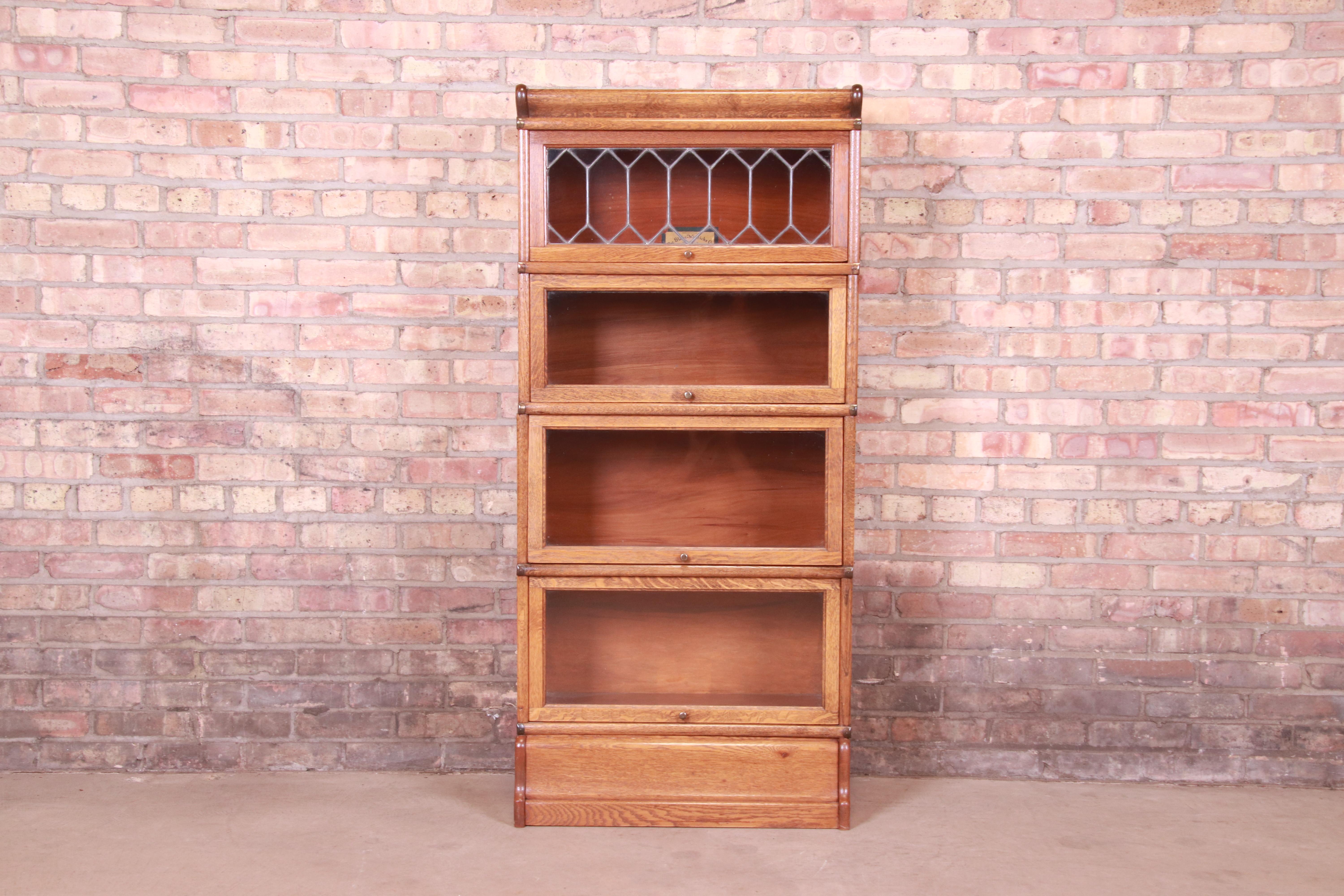 A gorgeous antique Arts & Crafts four-stack barrister bookcase with leaded glass

By Globe Wernicke

USA, Circa 1900

Quartersawn oak, with glass front doors and original brass hardware.

Measures: 25.5