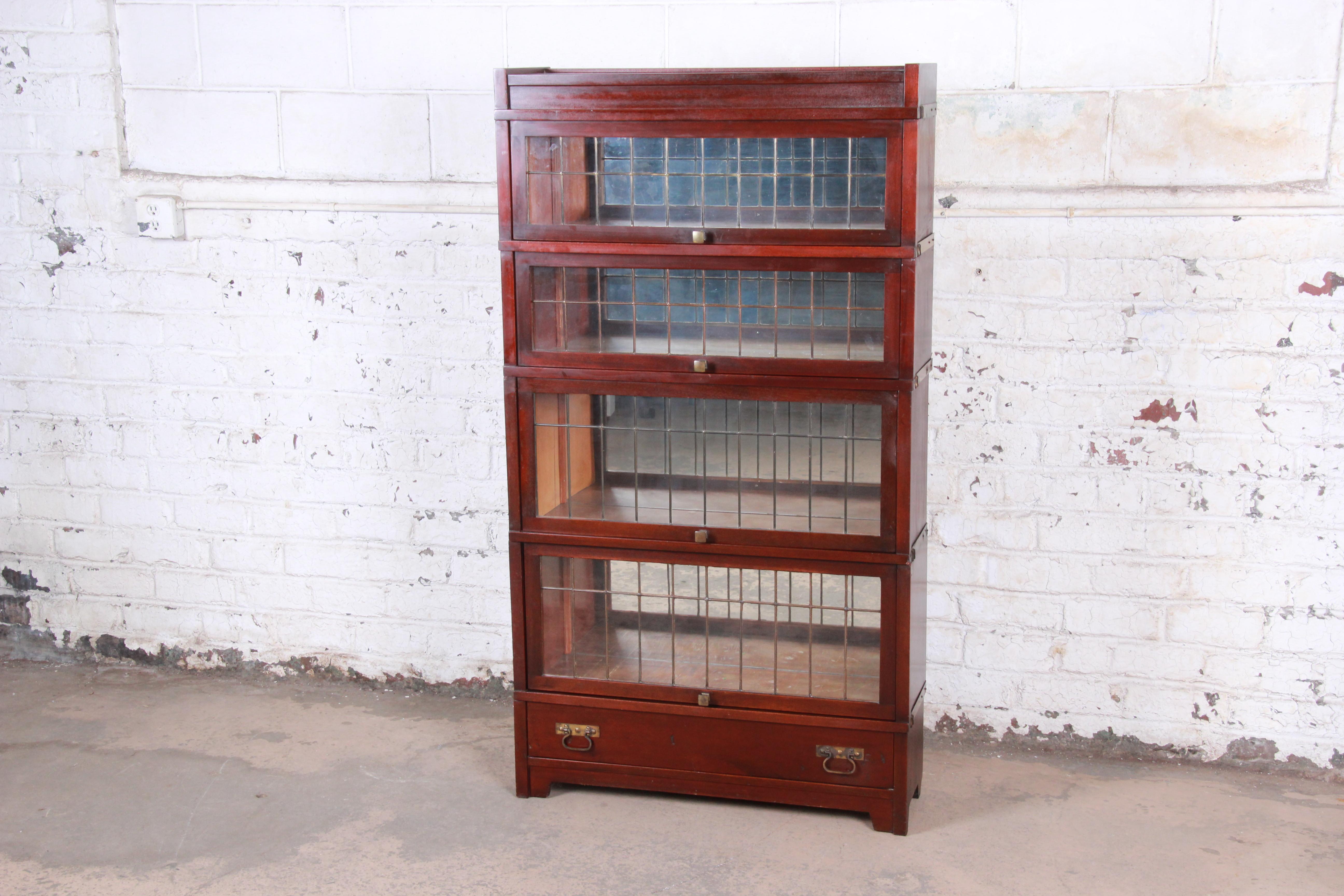 A rare and exceptional four-stack barrister bookcase with leaded glass doors

By Globe Wernicke

USA, circa 1920

Mahogany + leaded glass + brass hardware and trim + mirror

Measures: 34.63