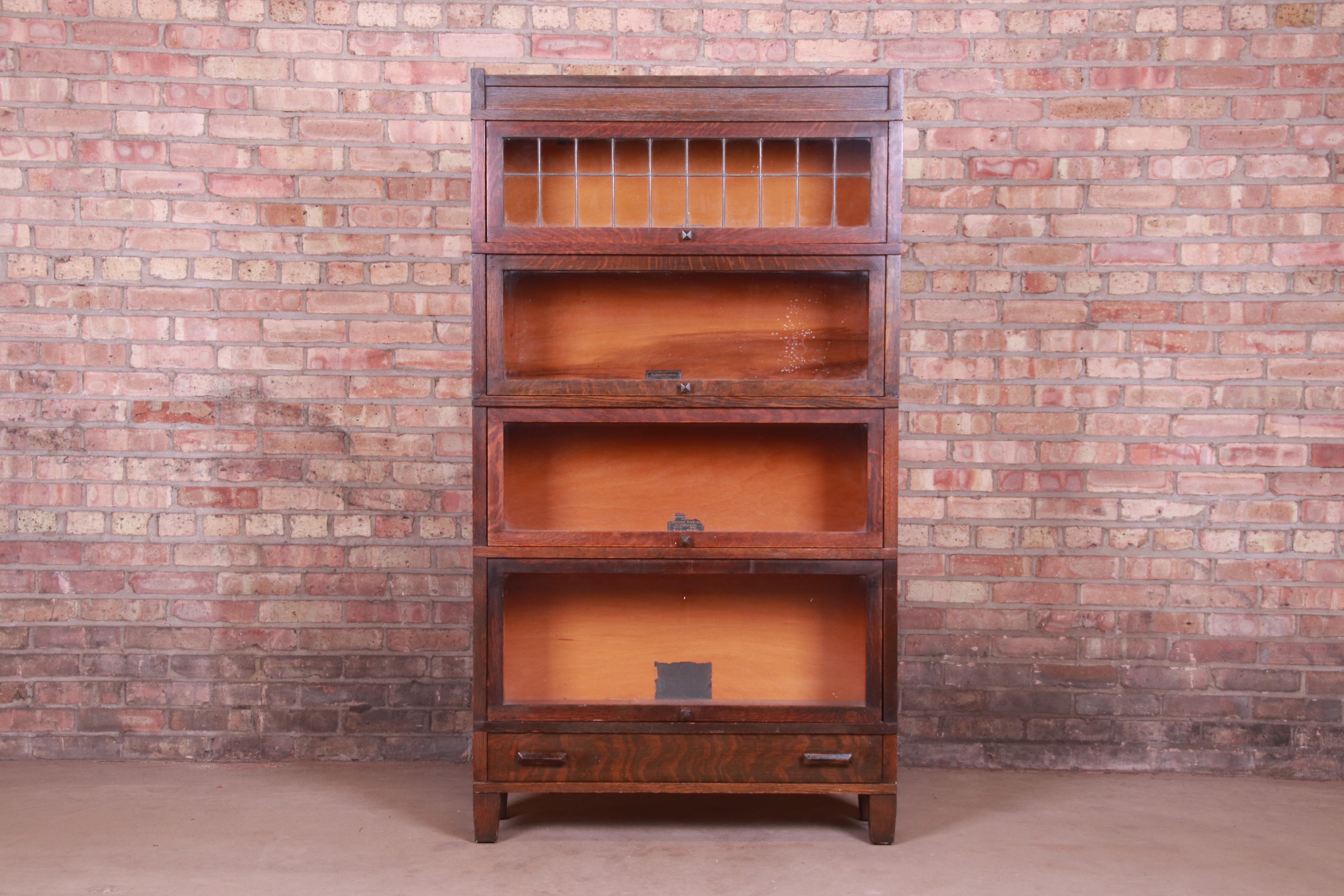 A gorgeous antique Arts & Crafts four-stack barrister bookcase

By Globe Wernicke

USA, circa 1920s

Quartersawn oak, with original leaded glass.

Measures: 34.63