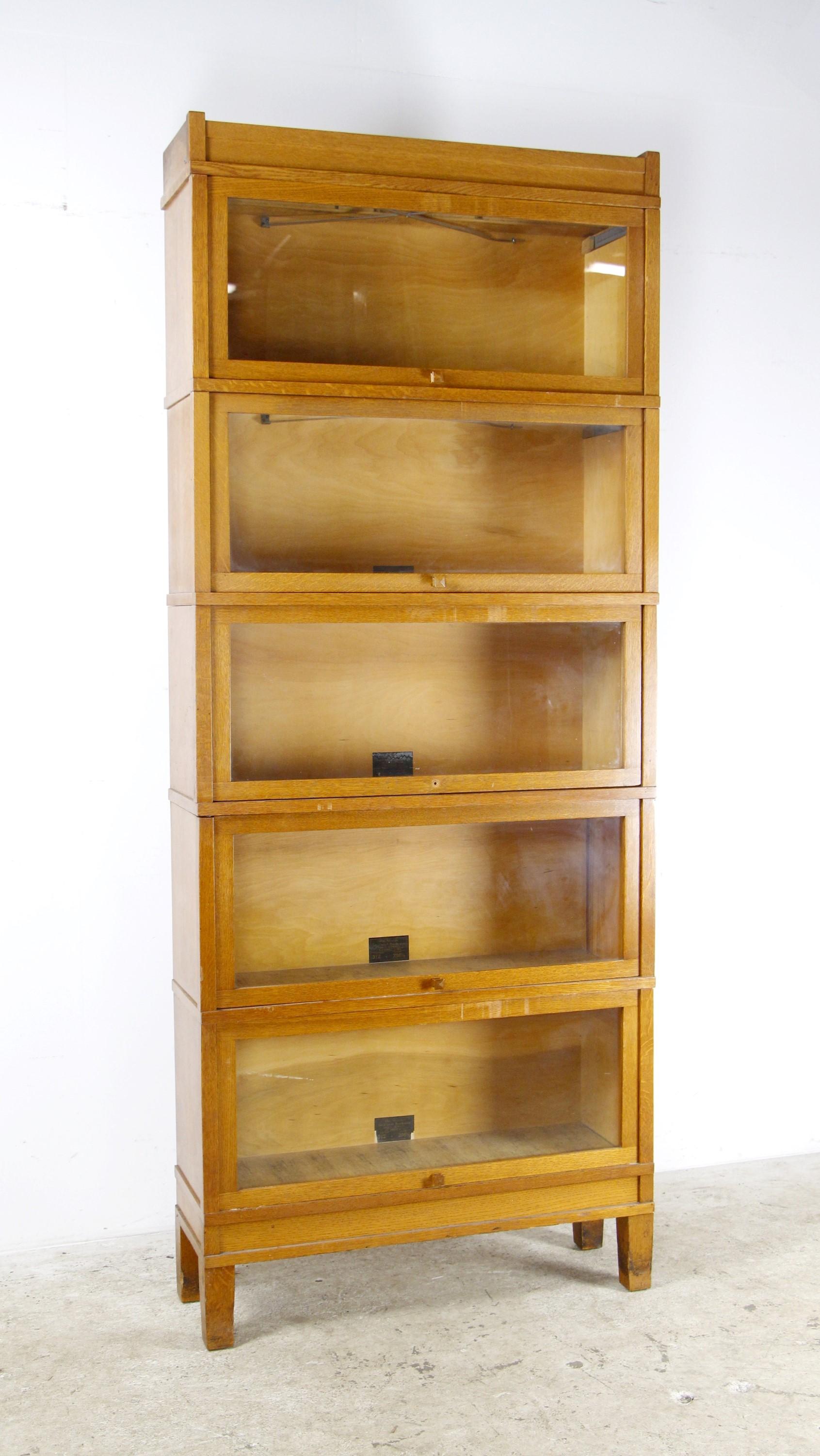 Globe-Wernicke Sectional Bookcase, Pattern 3-1/2 - Grade 298-1/2.  This oak five section barrister bookcase has a medium tone with glass front doors.  It includes the original wood door pulls (except for one that is missing).   Please see the